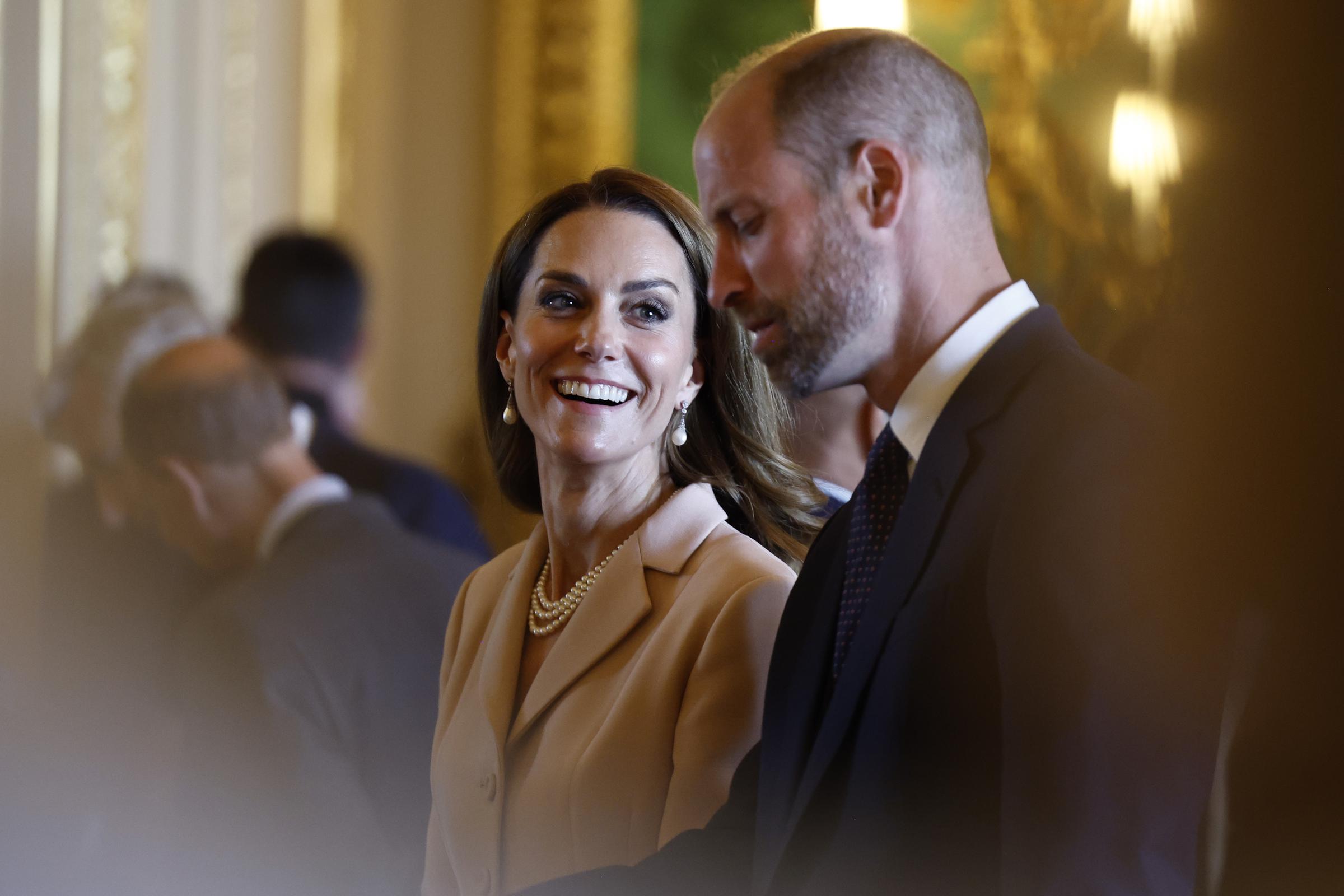 Princess Catherine gazes affectionately at her husband, Prince William, during the official welcome ceremony for French President Emmanuel Macron at Windsor Castle.