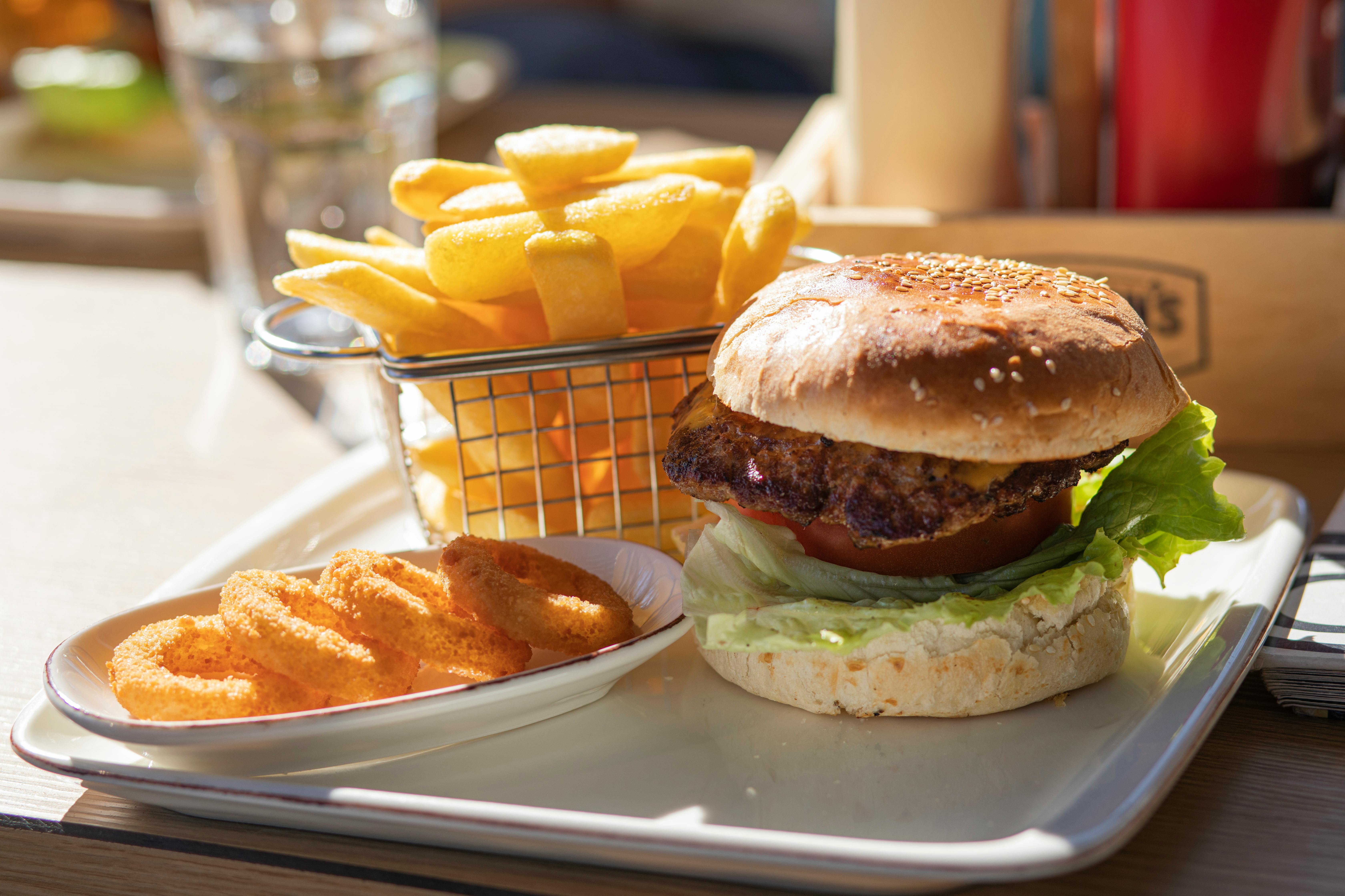 A tray of hamburger, fries, and onion rings | Source: Pexels