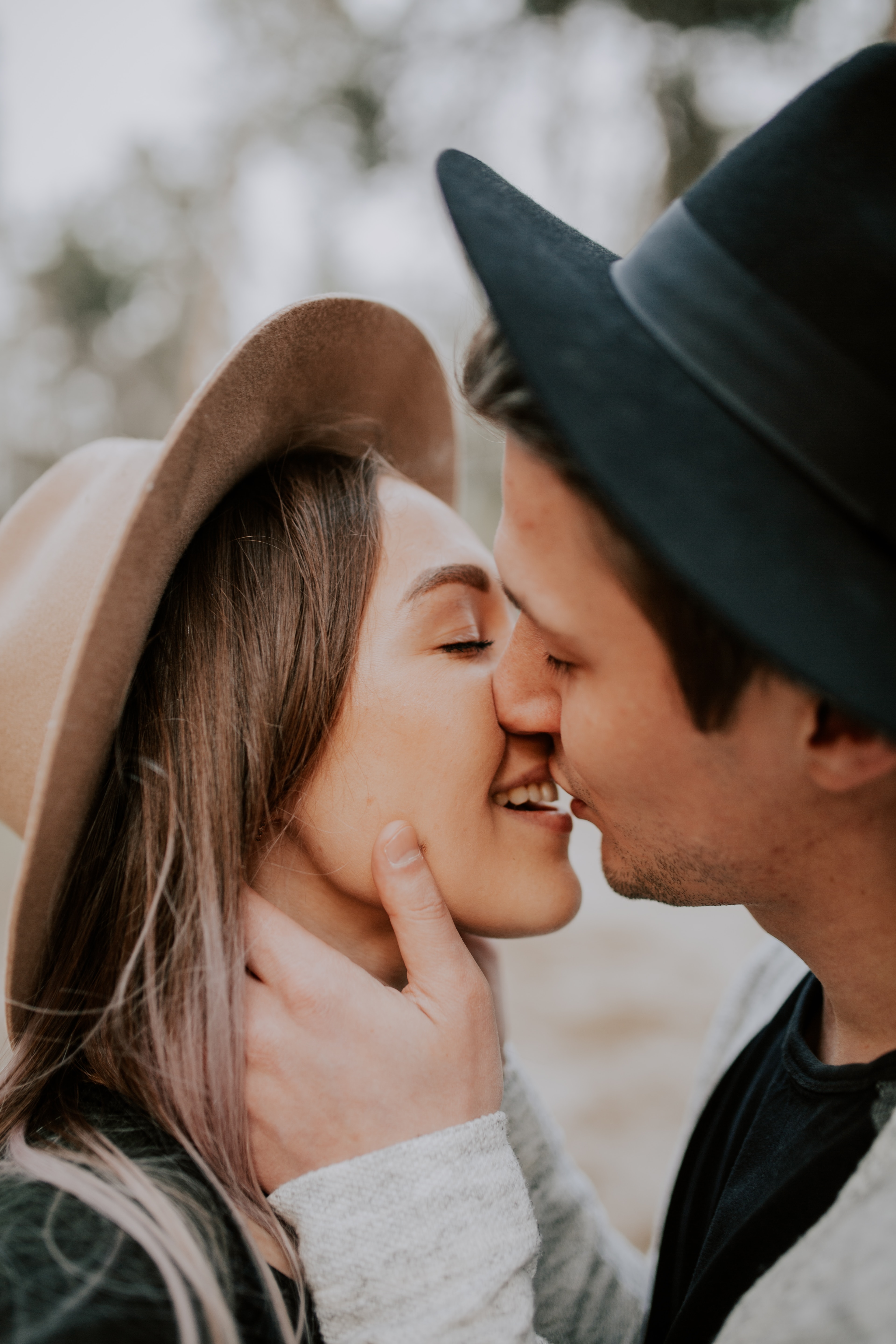 A photo of a couple kissing while smiling  | Source: Unsplash