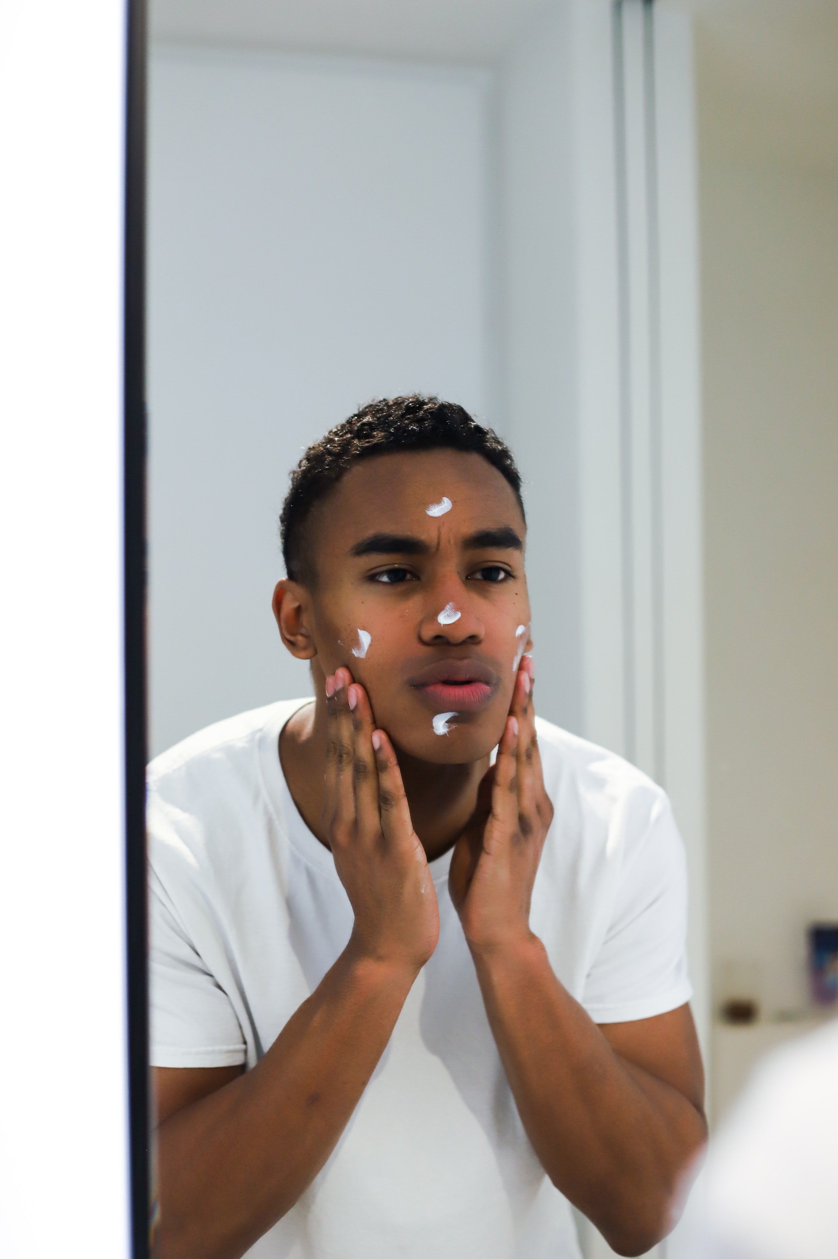 Man applying face cream | Unsplash 