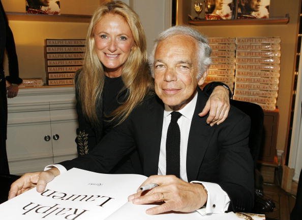 Ralph Lauren (R) signing his book with his wife Ricky Lauren (L) attend the celebration of Ralph Lauren's 40th Anniversary at Bergdorf Goodman on October 18, 2007, in New York City. | Source: Getty Images.