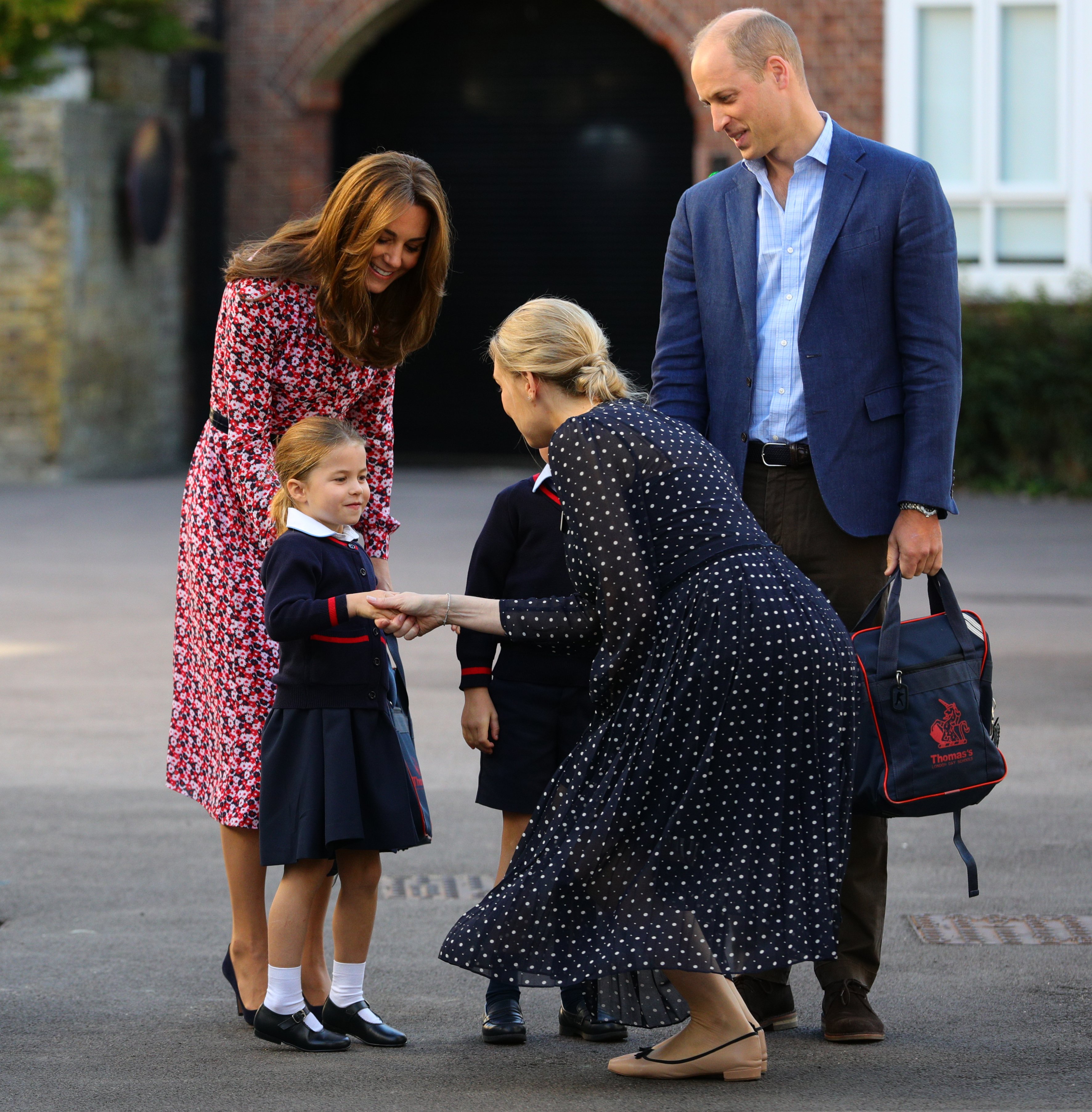 Helen Haslem pictured greeting Princess Charlotte as she arrives for her first day of school, and her parents Kate Middleton and Prince William, at Thomas's Battersea in London on September 5, 2019 in London, England. / Source: Getty Images