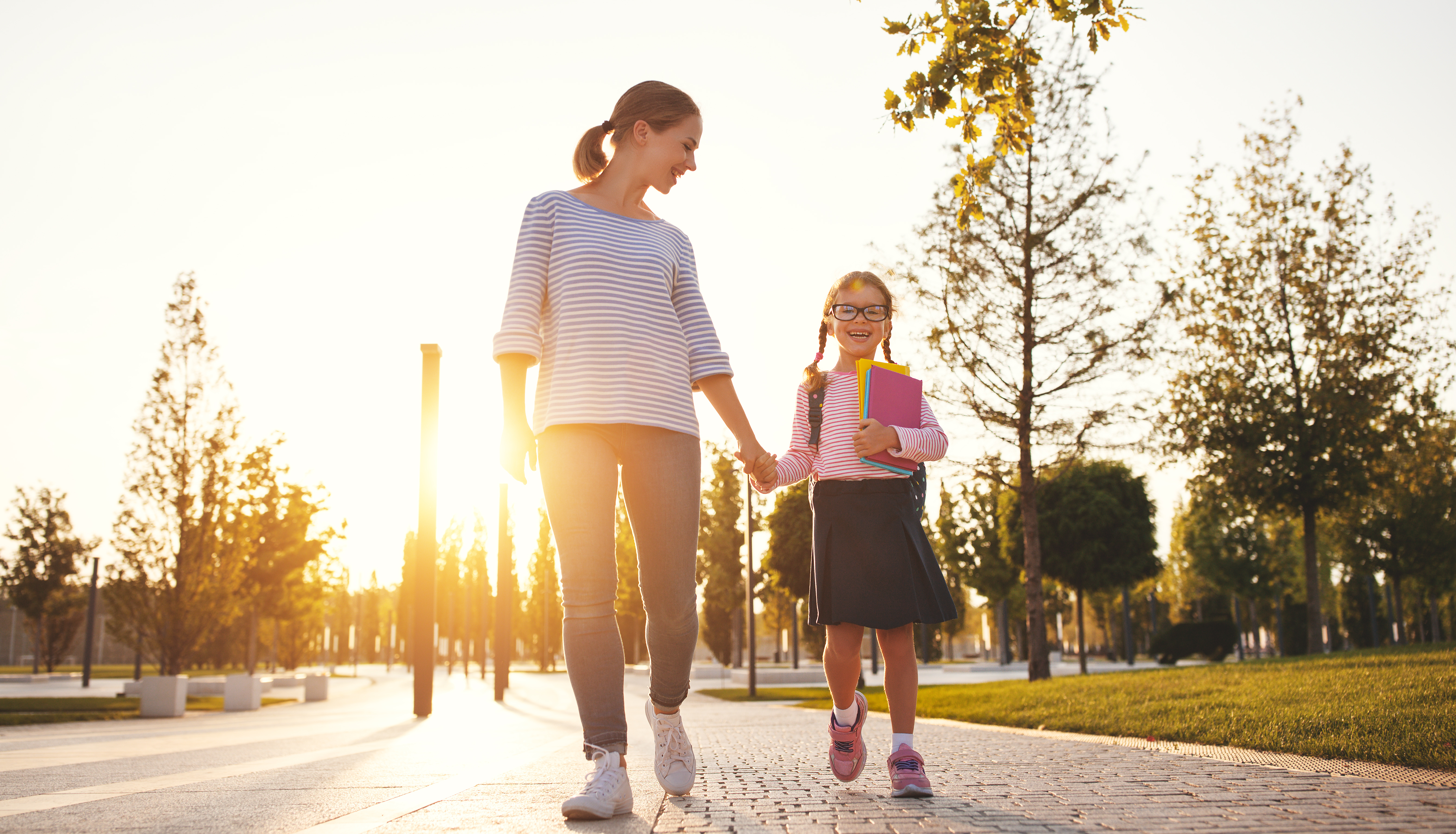 First day at school. mother leads little child school girl in first grade | Source: Getty Images