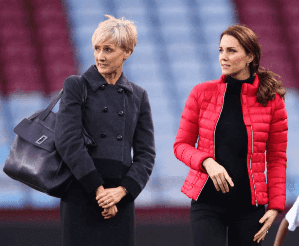 Kate Middleton stand on a soccer field with her private secretary, Catherine Quinn during a visit to Aston Villa Football Club, on November 22, 2017, in Birmingham, England. | Source: Max Mumby/Indigo/Getty Images