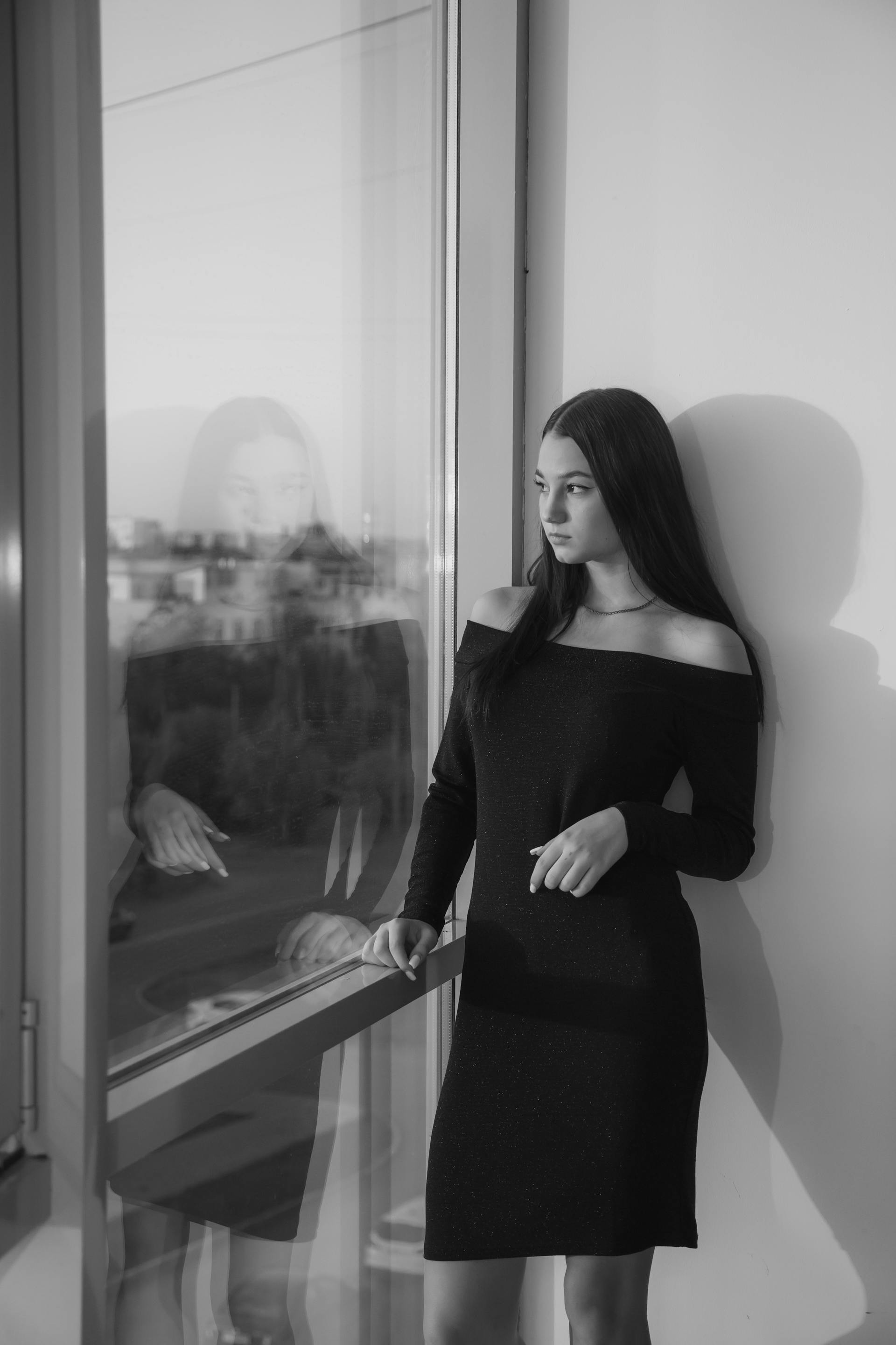 A woman standing next to a window | Source: Pexels