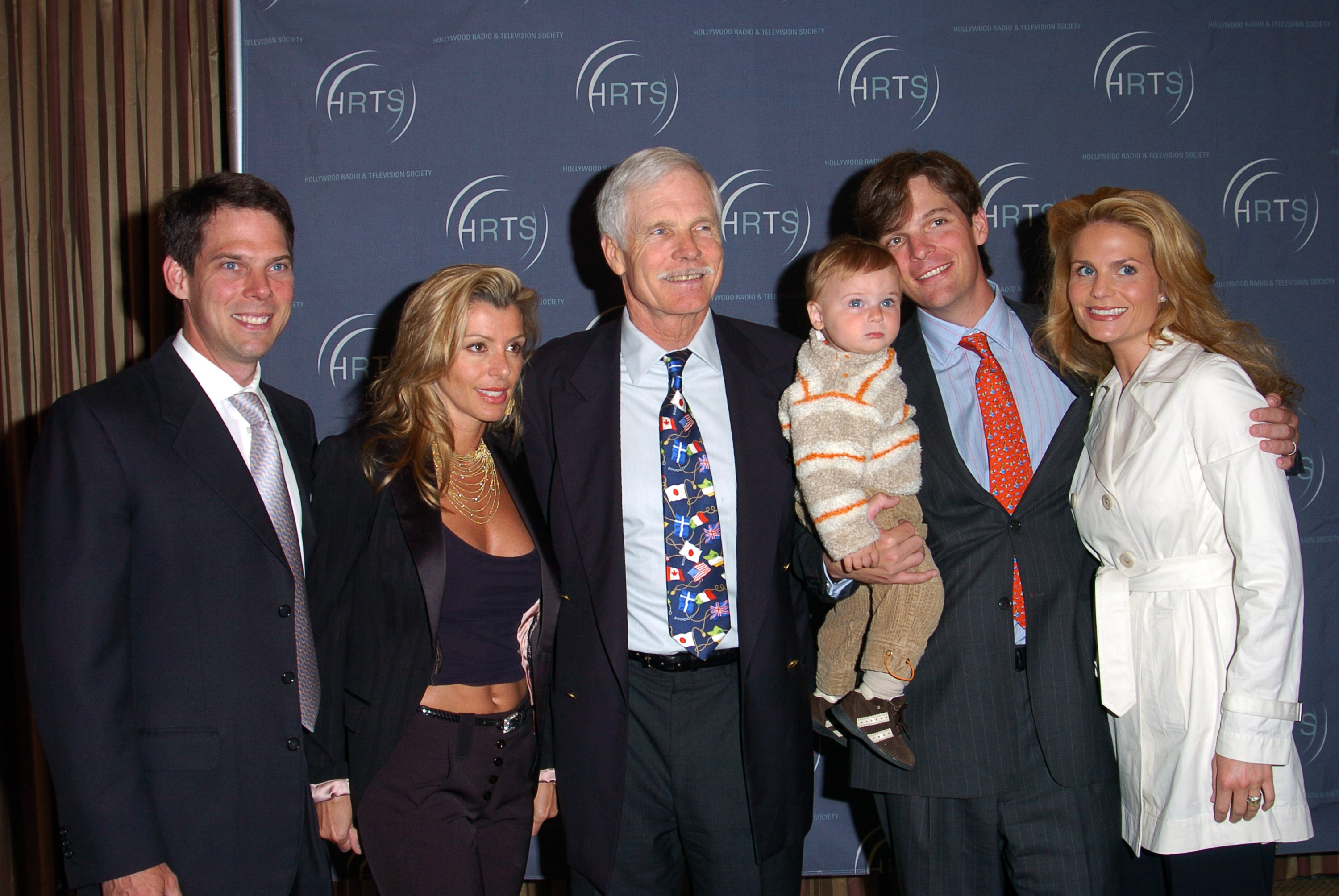 Rhett Turner, Angela D.C. Turner, Ted Turner, Beau Turner holding Beau Turner Jr., and Gana Hunt Turner attend the Hollywood Radio and Television Society's Newsmaker Luncheon on April 8, 2004 | Source: Getty Images