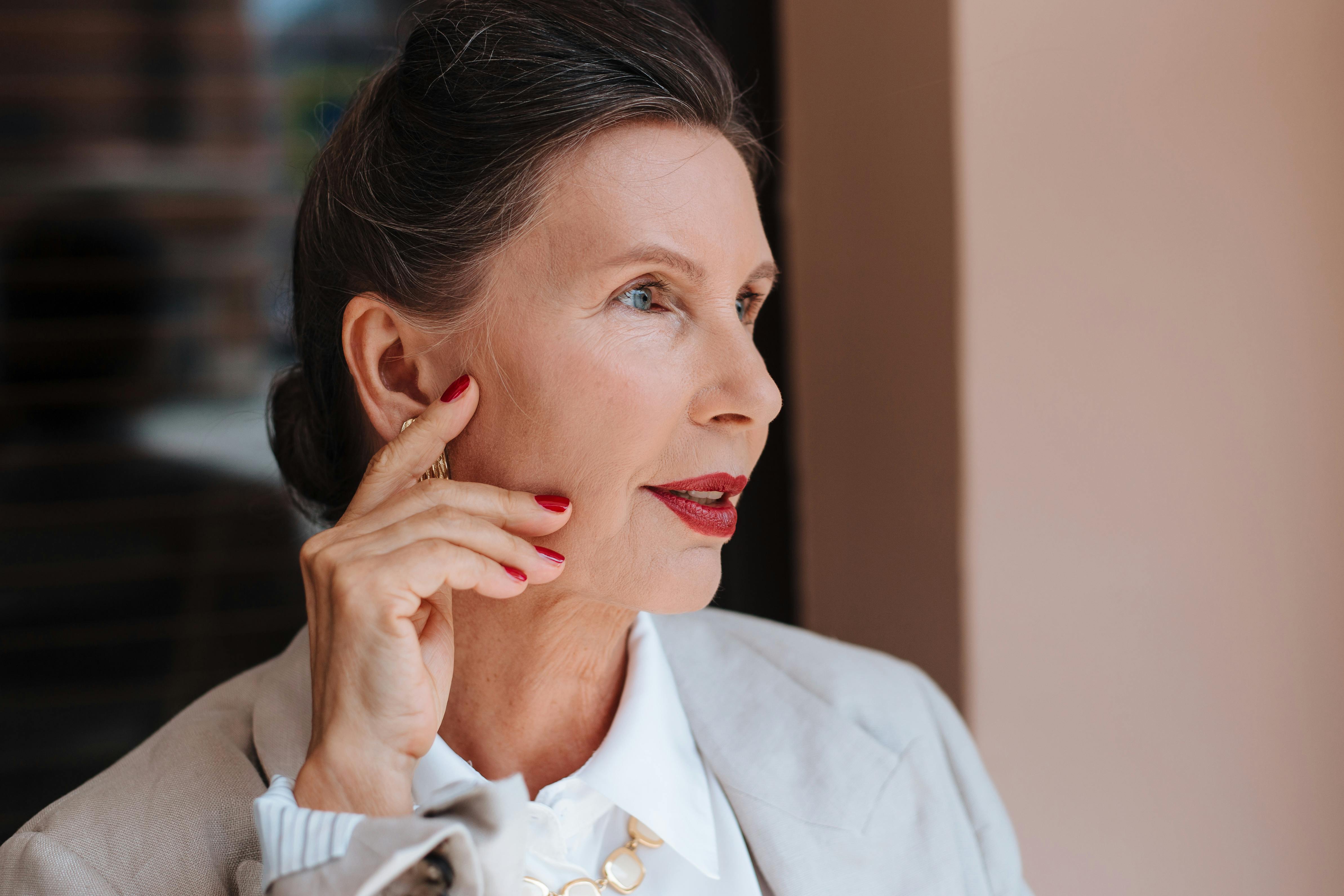 A woman gently touching her face | Source: Pexels