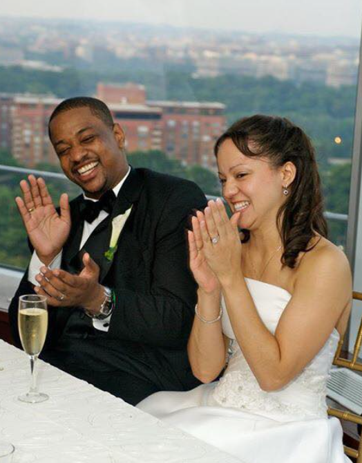 Justin and Cerina Fairfax sit together and applaud during their wedding reception in June 2006 | Source: Facebook/justin.fairfax.2025