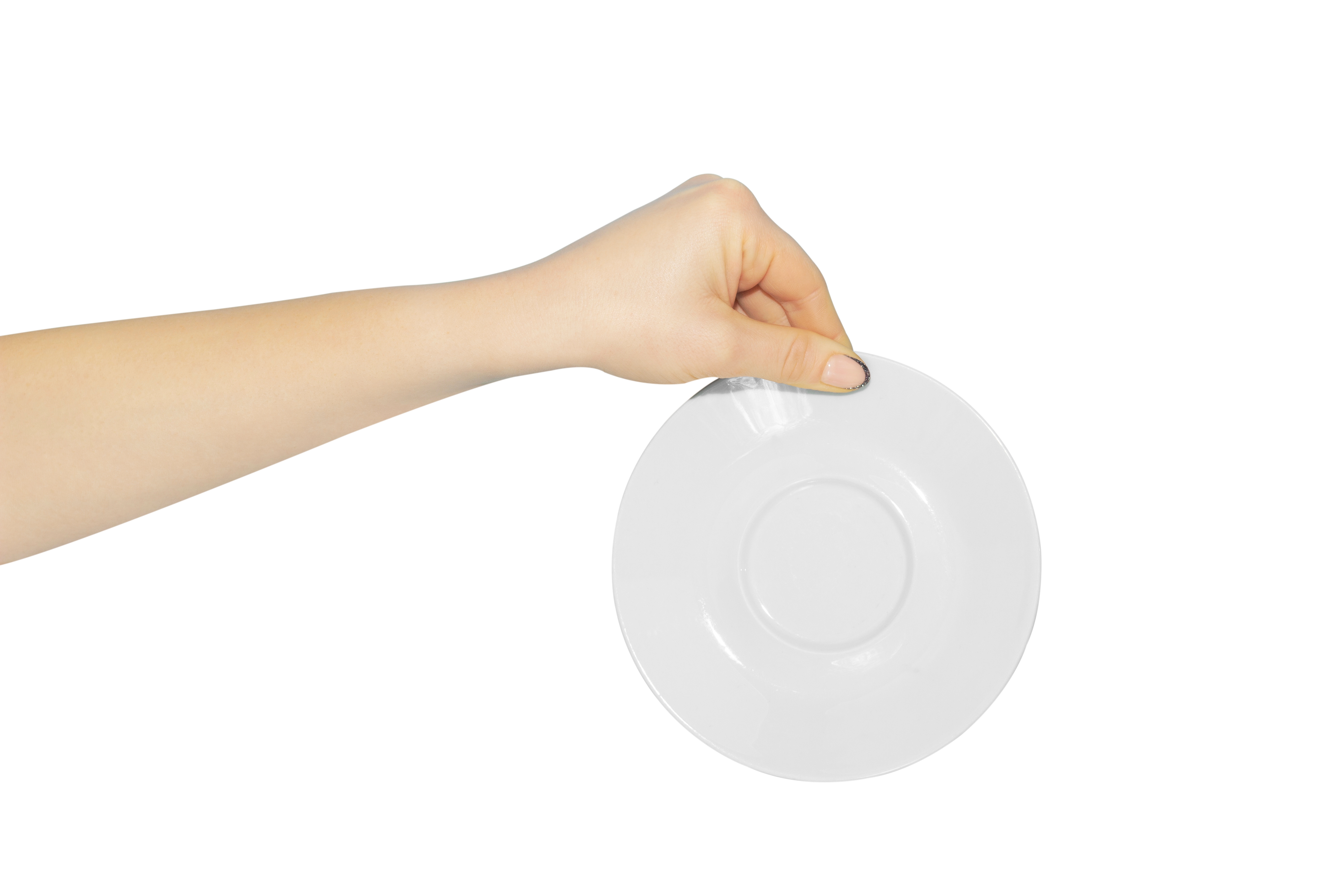 A woman's hand holding a saucer | Source: Shutterstock