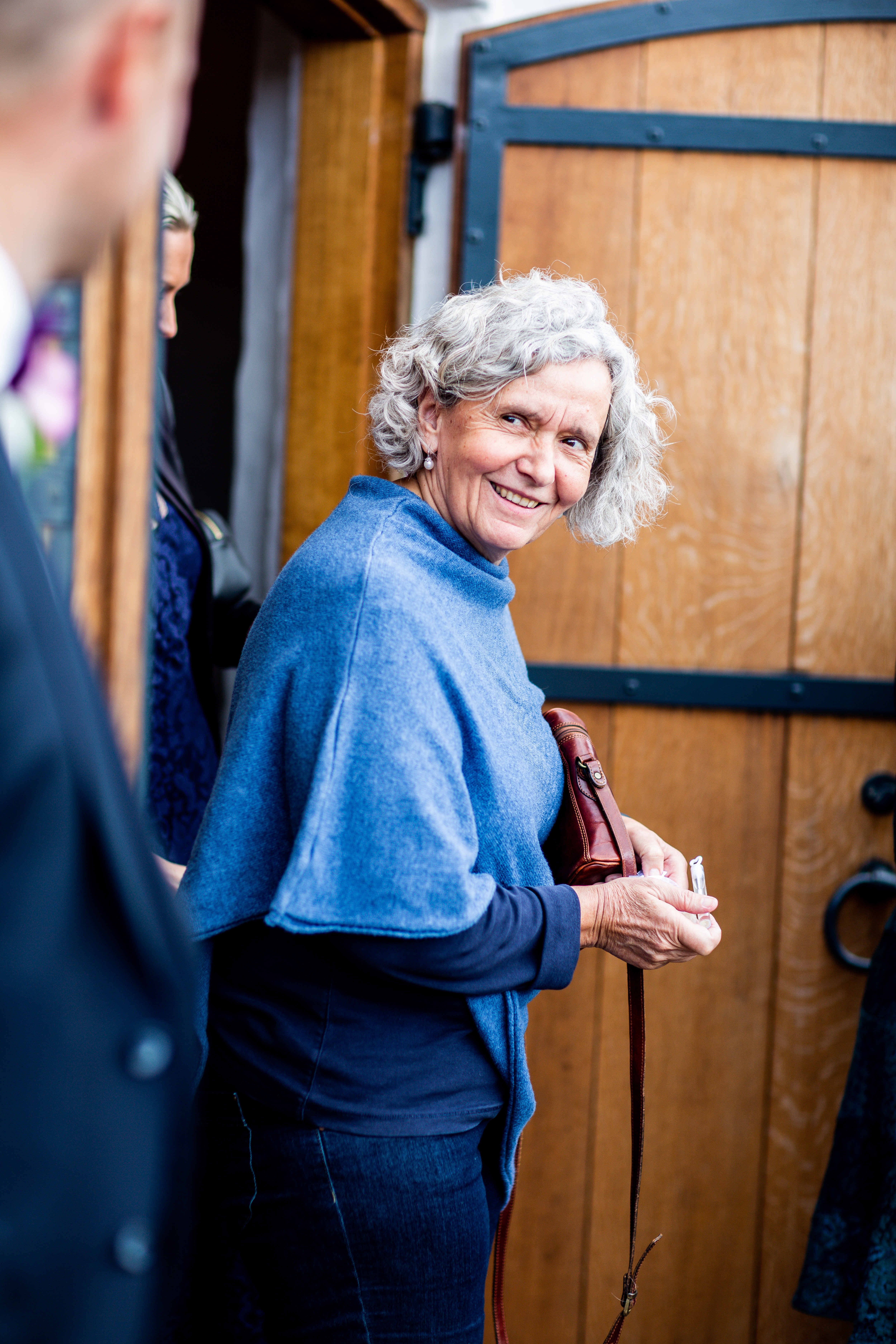 Pictured - A woman wearing a blue sweater carrying a brown leather bag | Source: Pexels 