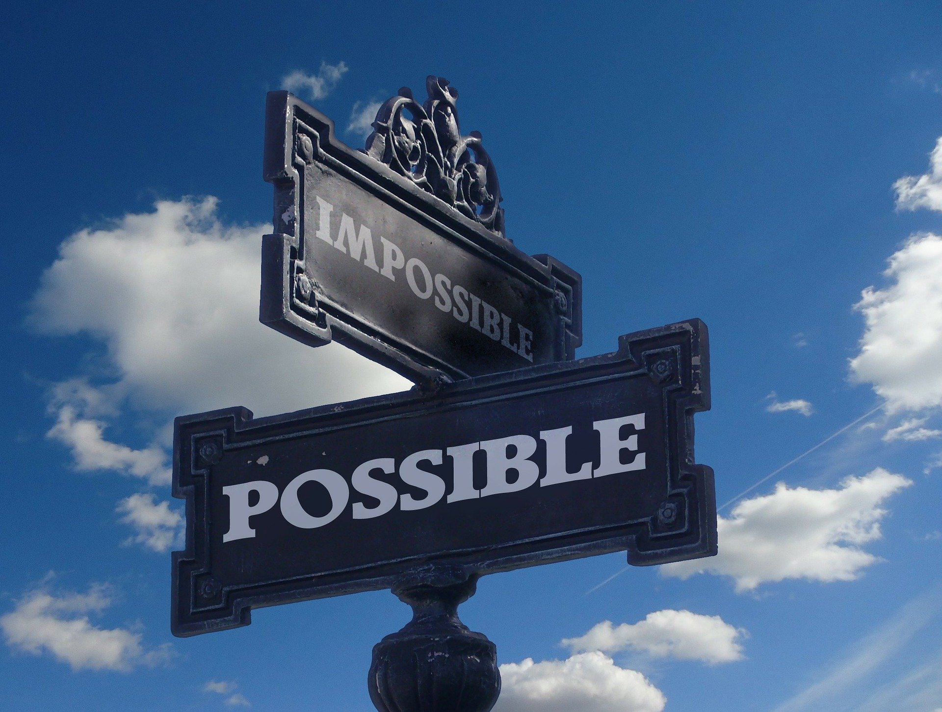 A streetsign supposedly pointing towards the "impossible" and the "possible." | Source: Pixabay.