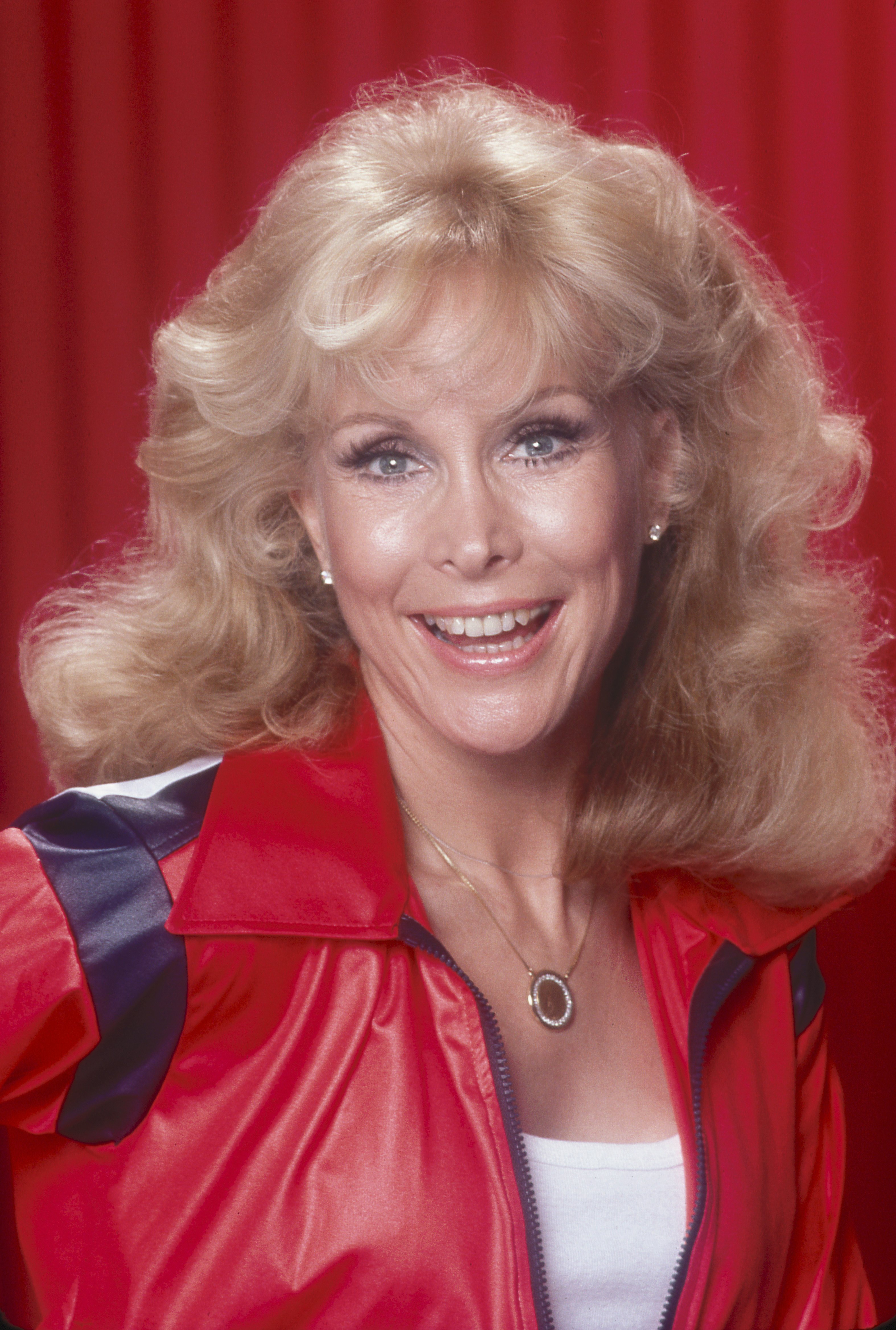 Barbara Eden poses in a red jacket and white top in 1990 in Los Angeles, California. | Source: Getty Images