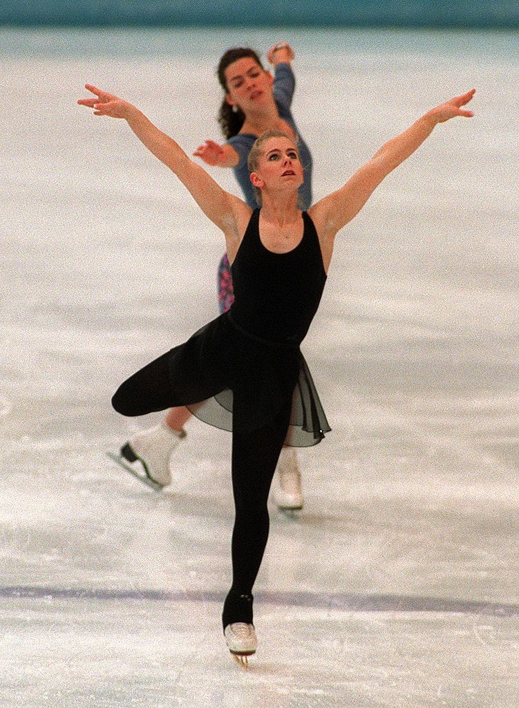 onya Harding (front) of the United States and compatriot Nancy Kerrigan skate during a practice session 22 February 1994 in Hamar, near Lillehammer, at the XVIIth Winter Olympic Games. | Source: Getty Images