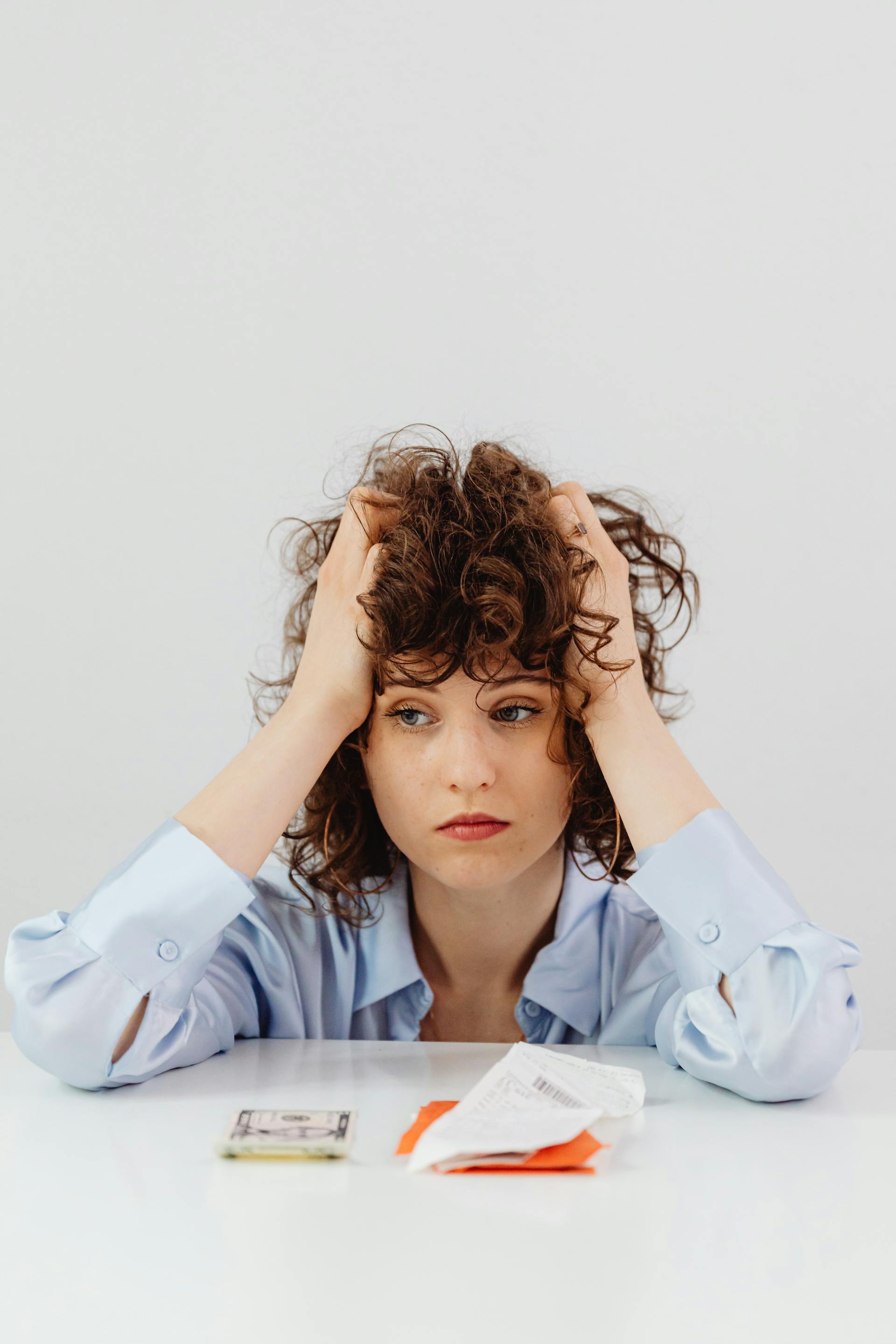 A distressed woman holding her head | Source: Pexels