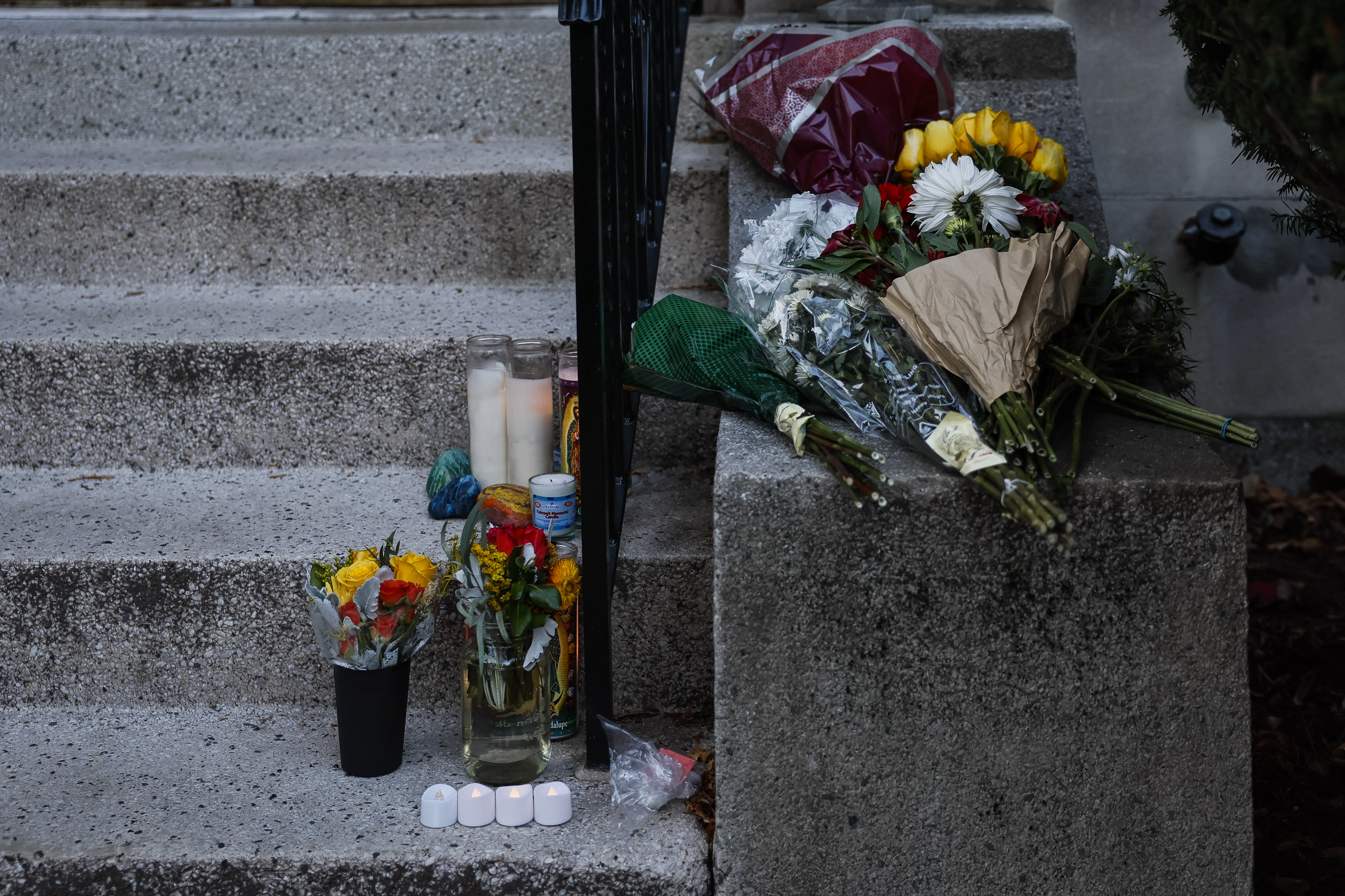 Flowers and candles rest on the front steps of Nuno F.G. Loureiro's home in Brookline on December 18, 2025. | Source: Getty Images