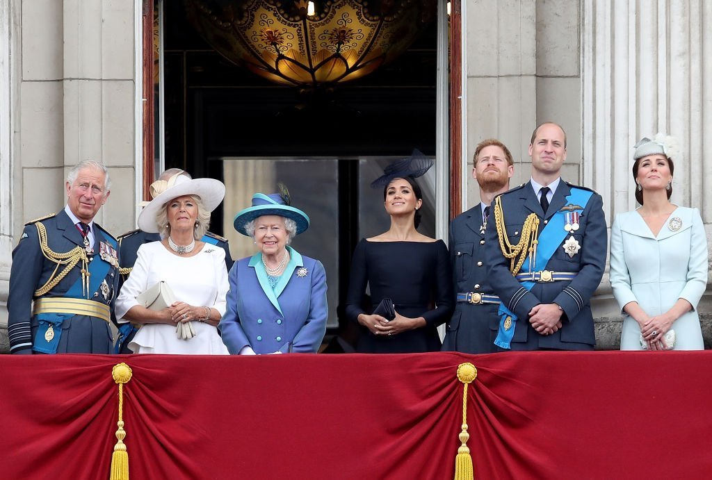 Prince Charles, Prince of Wales, Camilla, Duchess of Cornwall, Queen Elizabeth II, Meghan, Duchess of Sussex, Prince Harry, Duke of Sussex, Prince William, Duke of Cambridge and Catherine, Duchess of Cambridge watch the RAF flypast on the balcony of Buckingham Palace. | Photo: Getty Images
