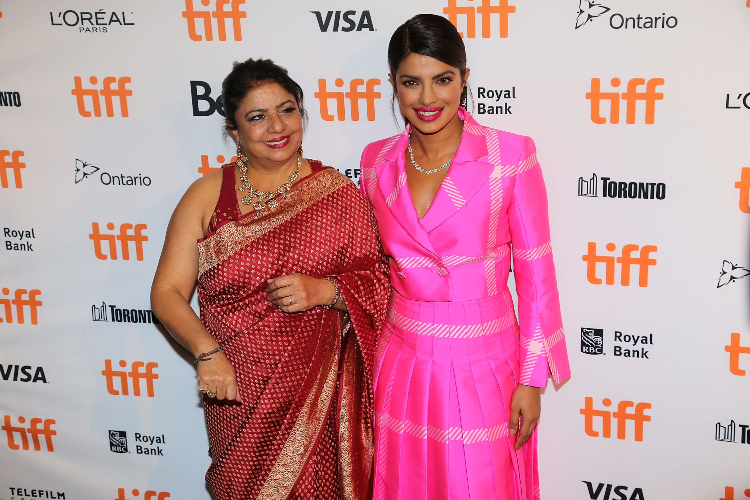 Dr Madhu Chopra and actress Priyanka Chopra (R) arrive at the 'Pahuna: The Little Visitors' premiere during the 2017 Toronto International Film Festival on September 7, 2017 in Toronto, Canada. | Source: Getty Images