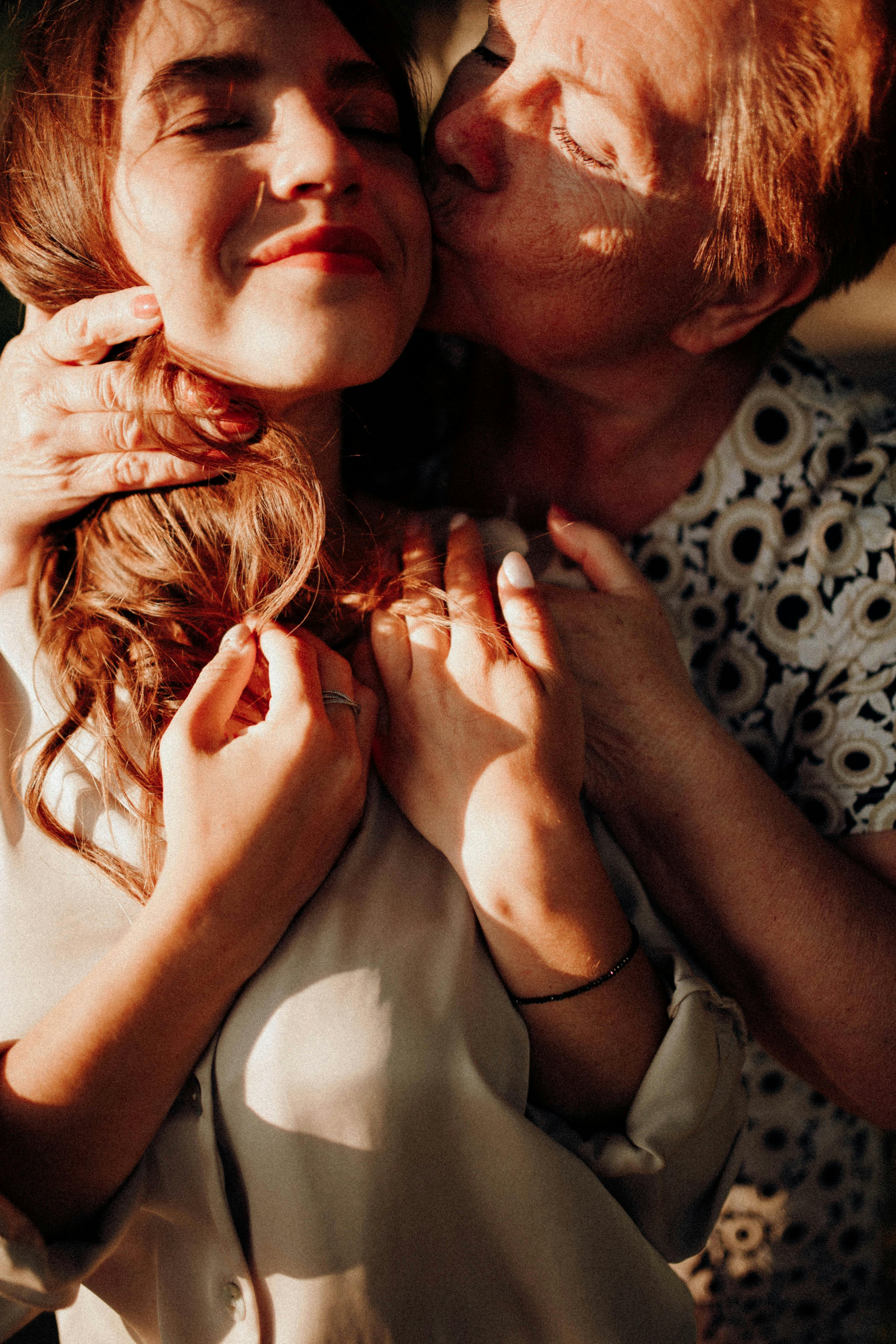 A mother kissing her daughter | Source: Pexels