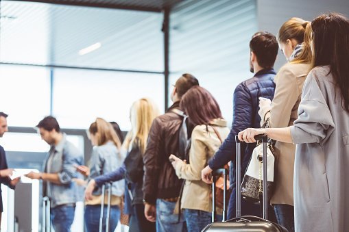 People at the boarding gate of an airport | Photo: Getty Images