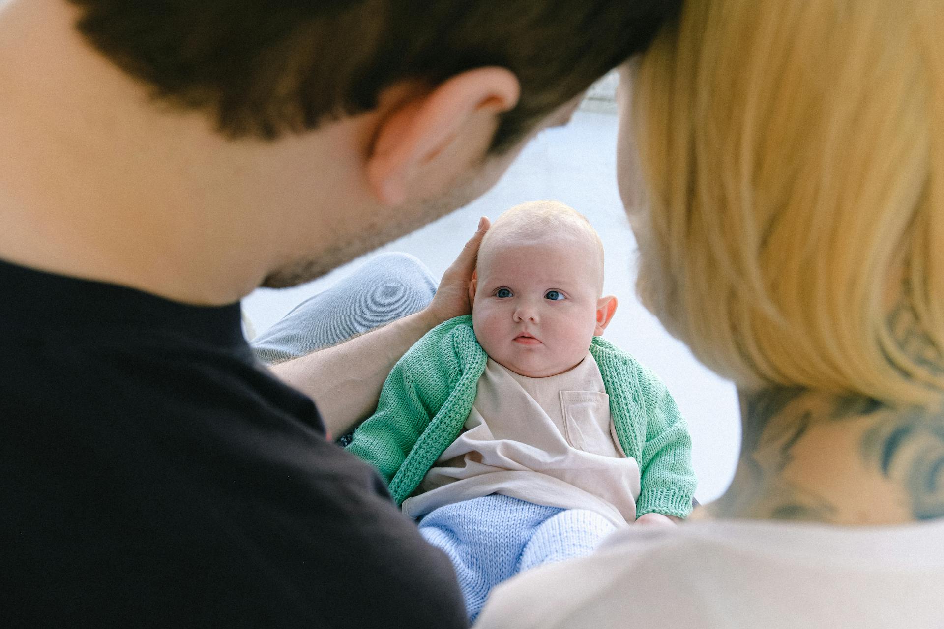 A couple holding a baby | Source: Pexels