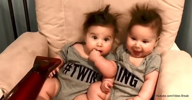 Adorable moment when identical twins grin & giggle while getting hair blow dried went viral in 2018