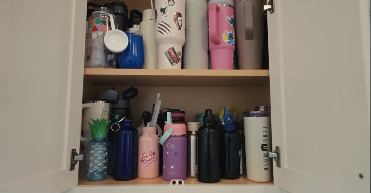 A dedicated kitchen cabinet packed with colorful insulated water tumblers. | Source: YouTube/@Archdigest