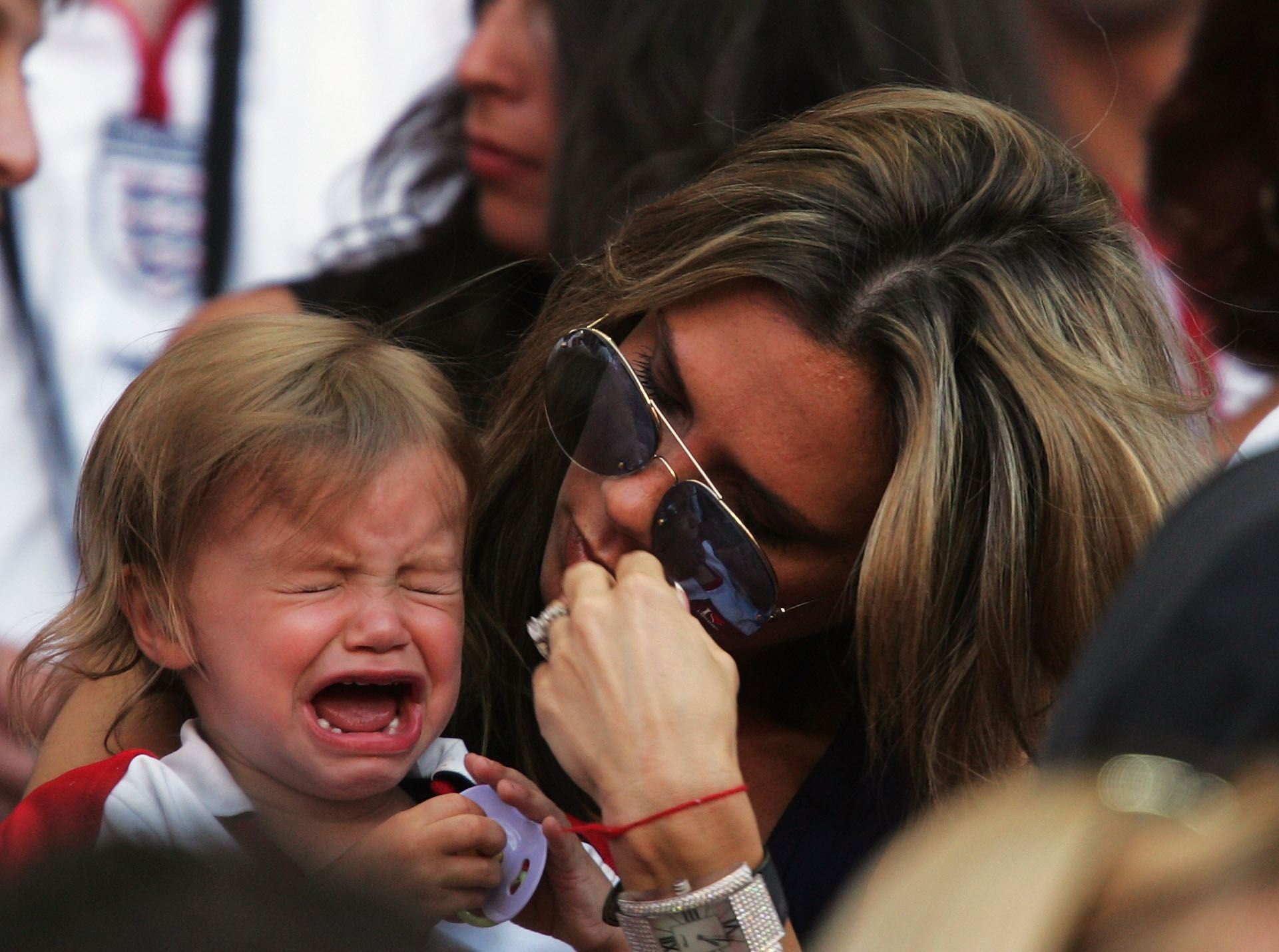 Romeo Beckham consoled by his mom in Lisbon, Portugal on June 13, 2004 | Source: Getty Images