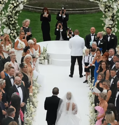 Conor McGregor Jr. stands at the front of the wedding aisle behind Terry Kavanagh on August 17, 2024 | Source: Instagram/odicci_films