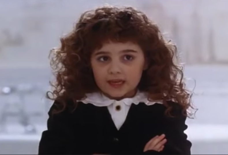 Alisan Porter as Curly Sue from the 1991 film, "Curly Sue," from a video dated July 16, 2014 | Source: YouTube/@RottenTomatoesCLASSICTRAILERS