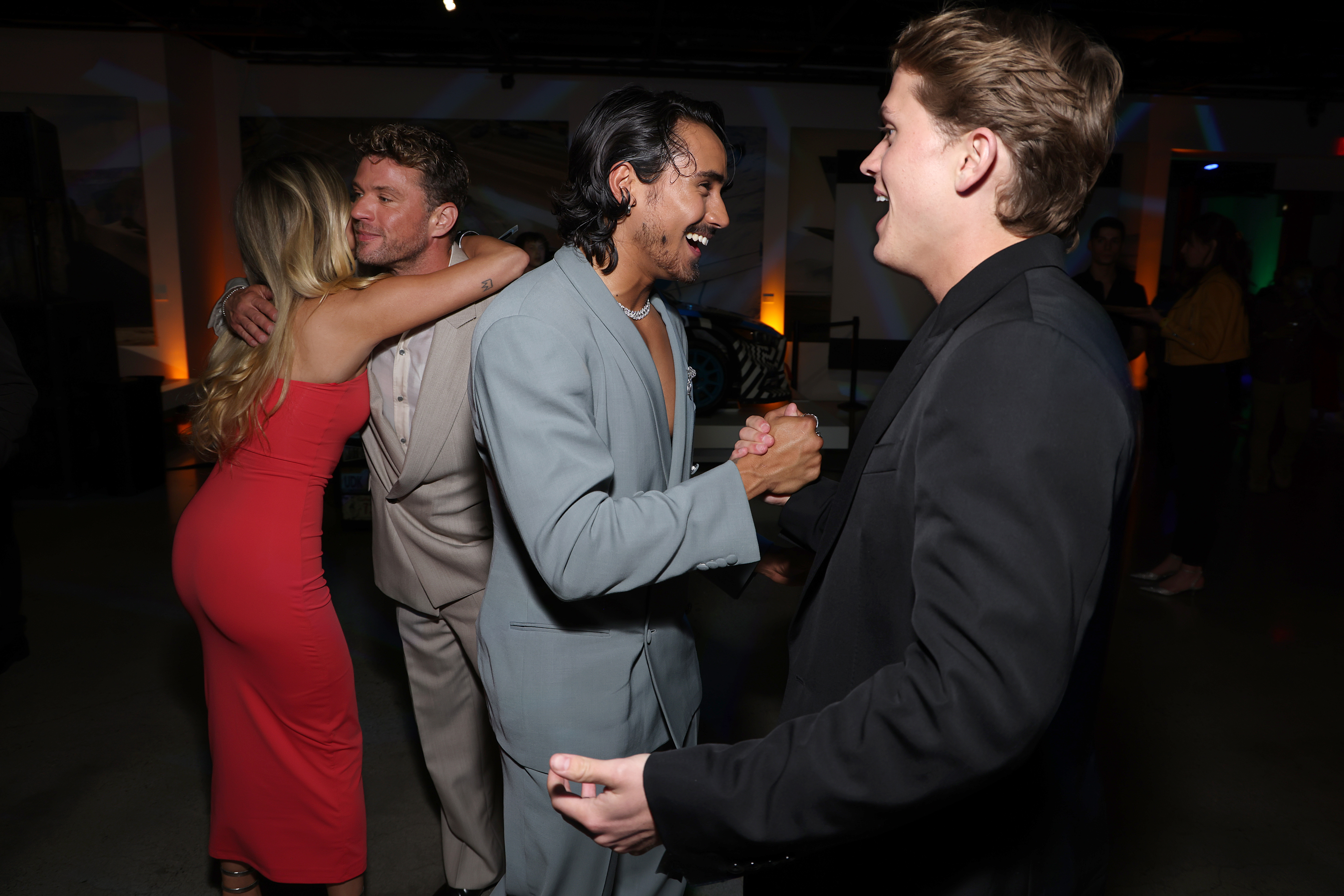 Mia Healey, Ryan Phillippe, Michael Cimino, and Deacon Phillippe enjoy a lively moment at the "Motorheads" screening inside the Academy Museum, dressed in eye-catching formal wear while mingling with fellow guests.