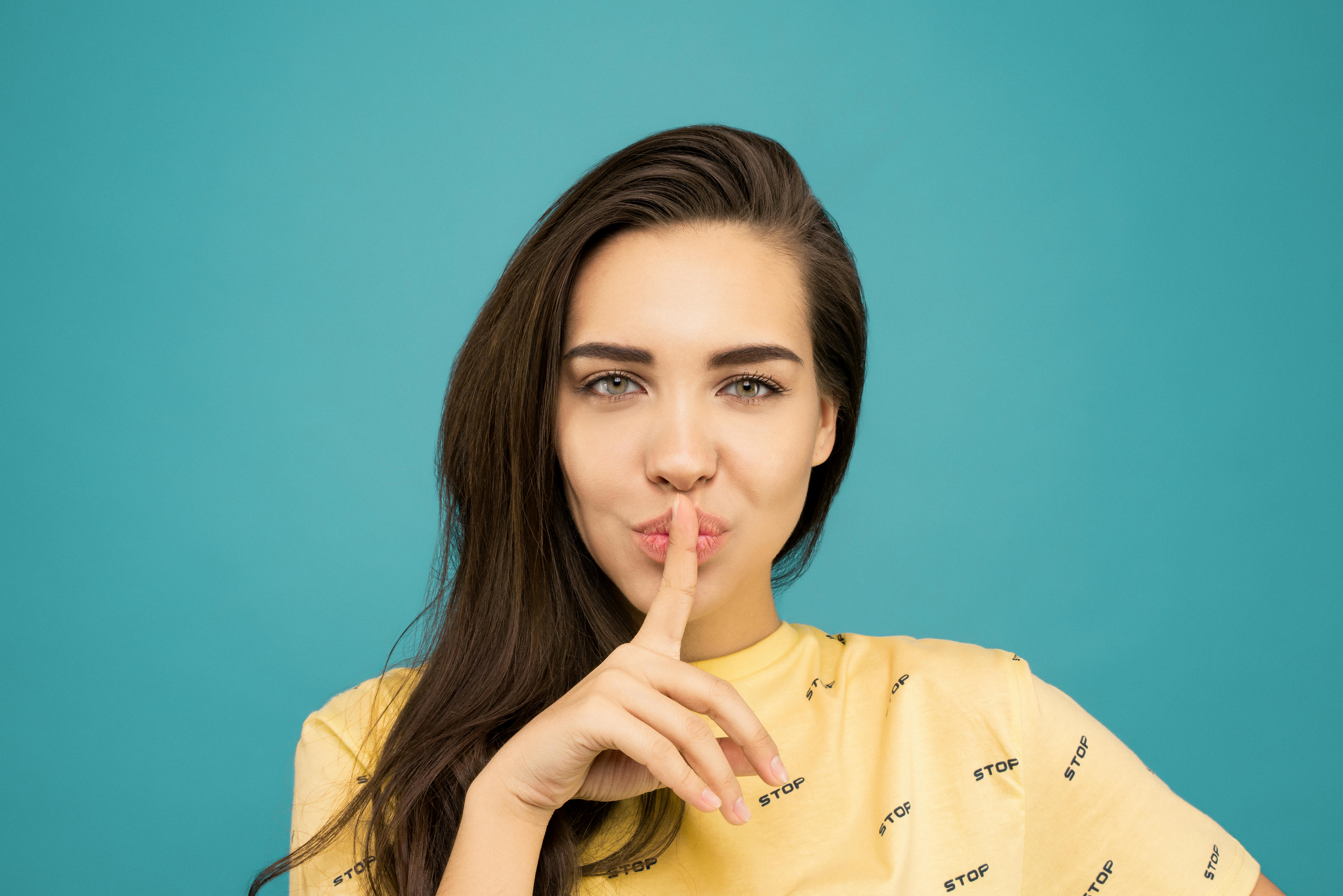 A woman with her finger to her mouth | Source: Pexels