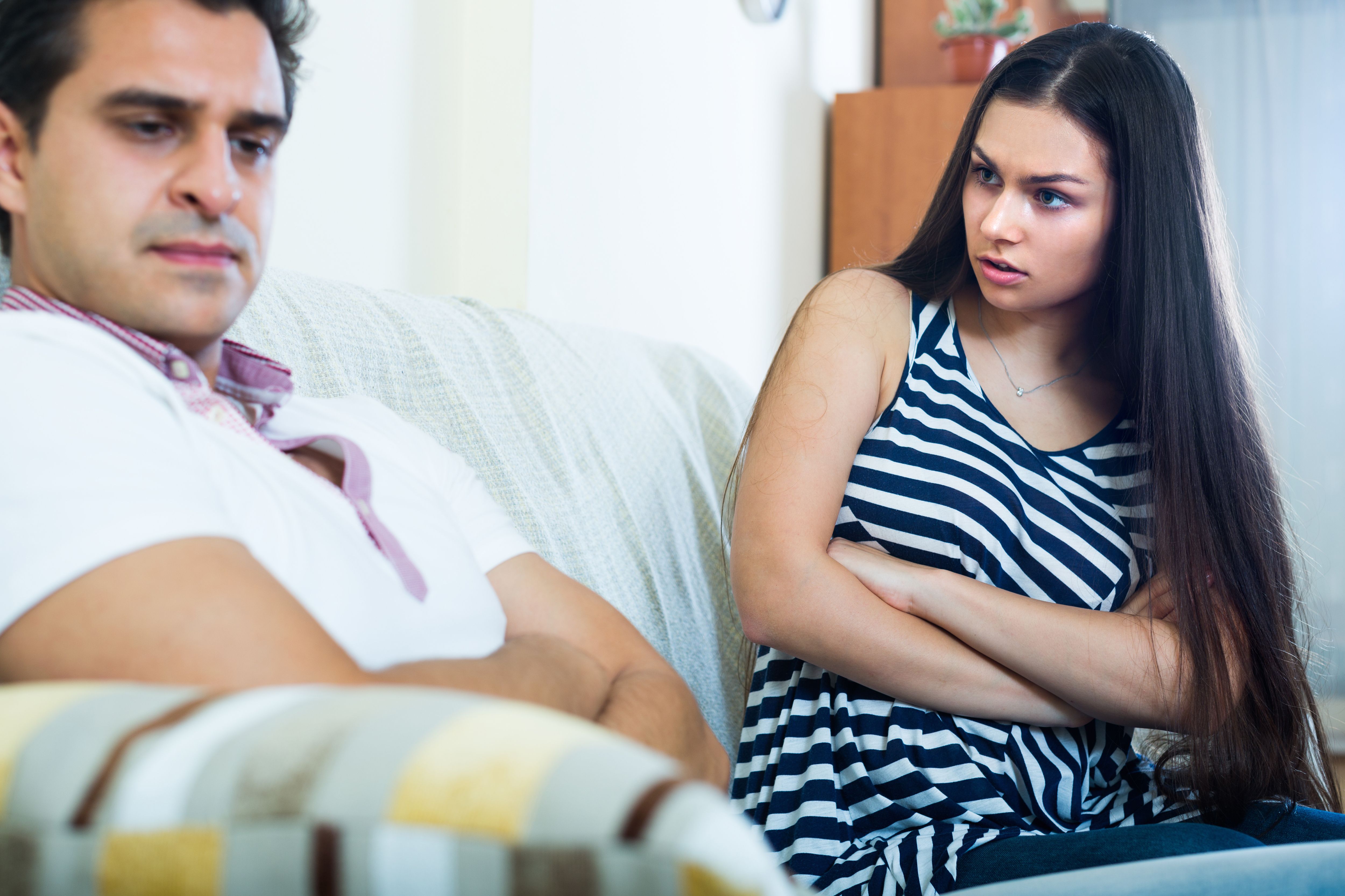 A woman looks upset while talking to her husband. | Source: Shutterstock