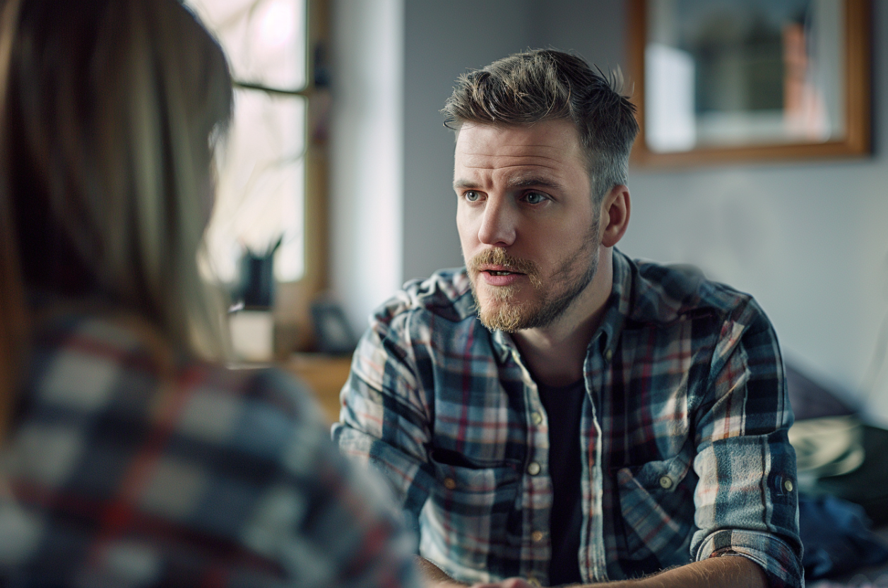 A man and woman speaking in a kitchen | Source: Midjourney