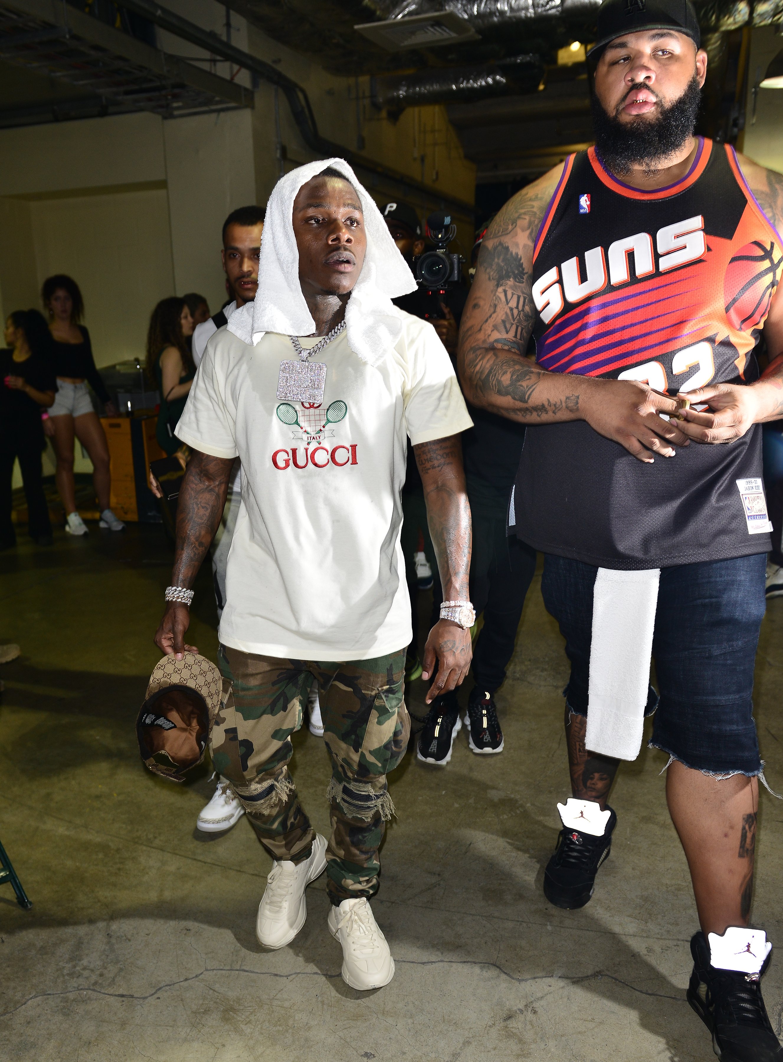 DaBaby walking beside his bodyguard on September 27, 2019 | Source: Getty Images
