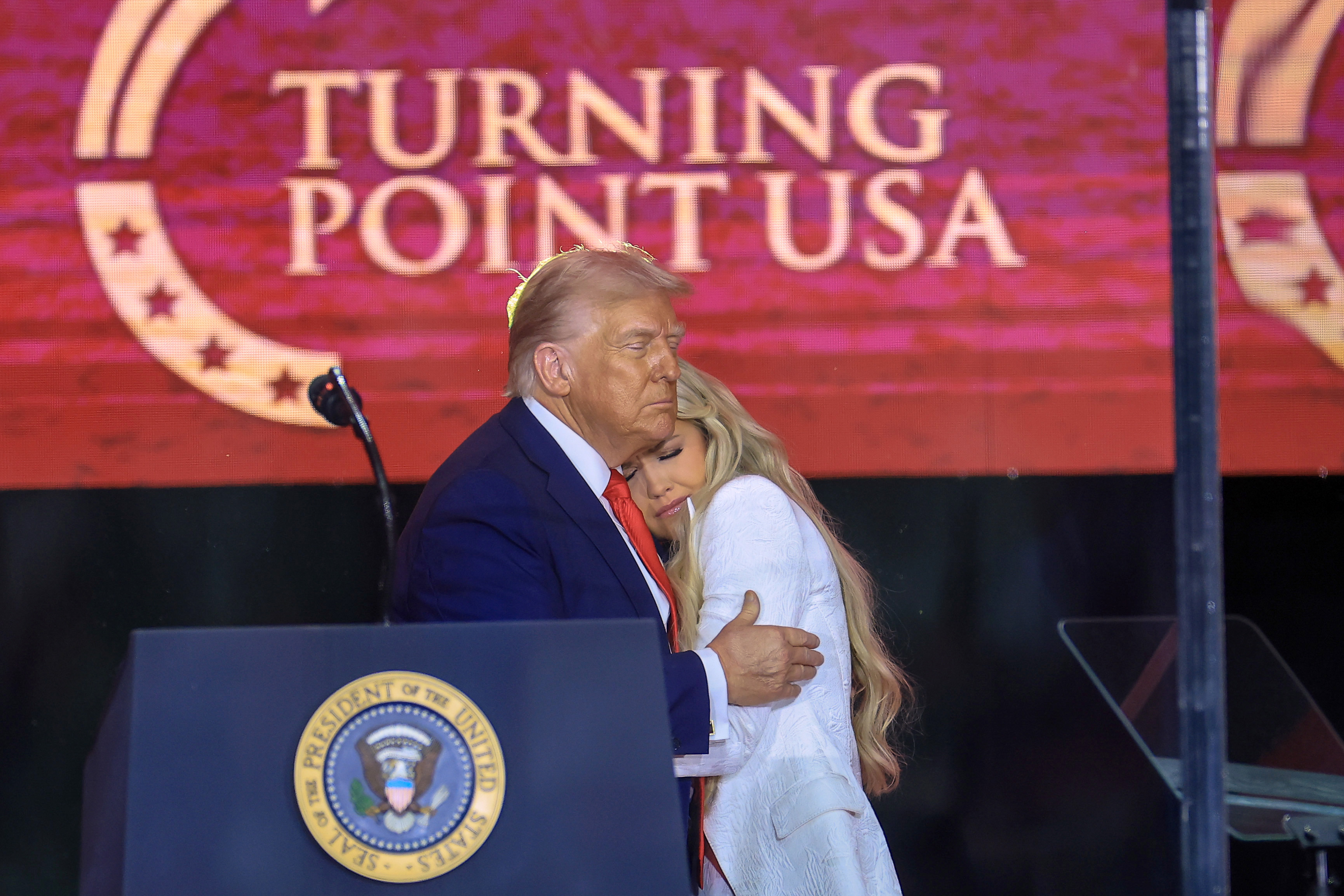 President Donald Trump comforts Erika Kirk onstage during the public memorial service for Charlie Kirk at State Farm Stadium on September 21, 2025 | Source: Getty Images