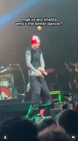 MGK responds with his own moves during the lighthearted contest, drawing attention from concertgoers gathered near the front of the stage. The rapper appears fully focused as he takes his turn in the friendly competition with Khalifa. | Source: Instagram/mgkmagic