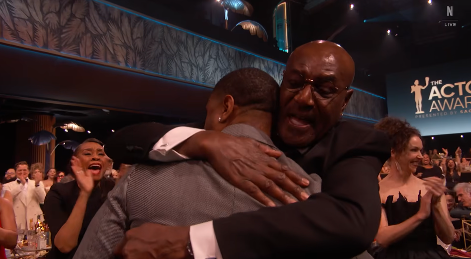 Michael B. Jordan hugs Delroy Lindo after winning the award for Outstanding Performance by a Male Actor in a Leading Role during the 32nd Annual Actor Awards at Shrine Auditorium and Expo Hall on March 1, 2026, in Los Angeles, California | Source: YouTube/Netflix