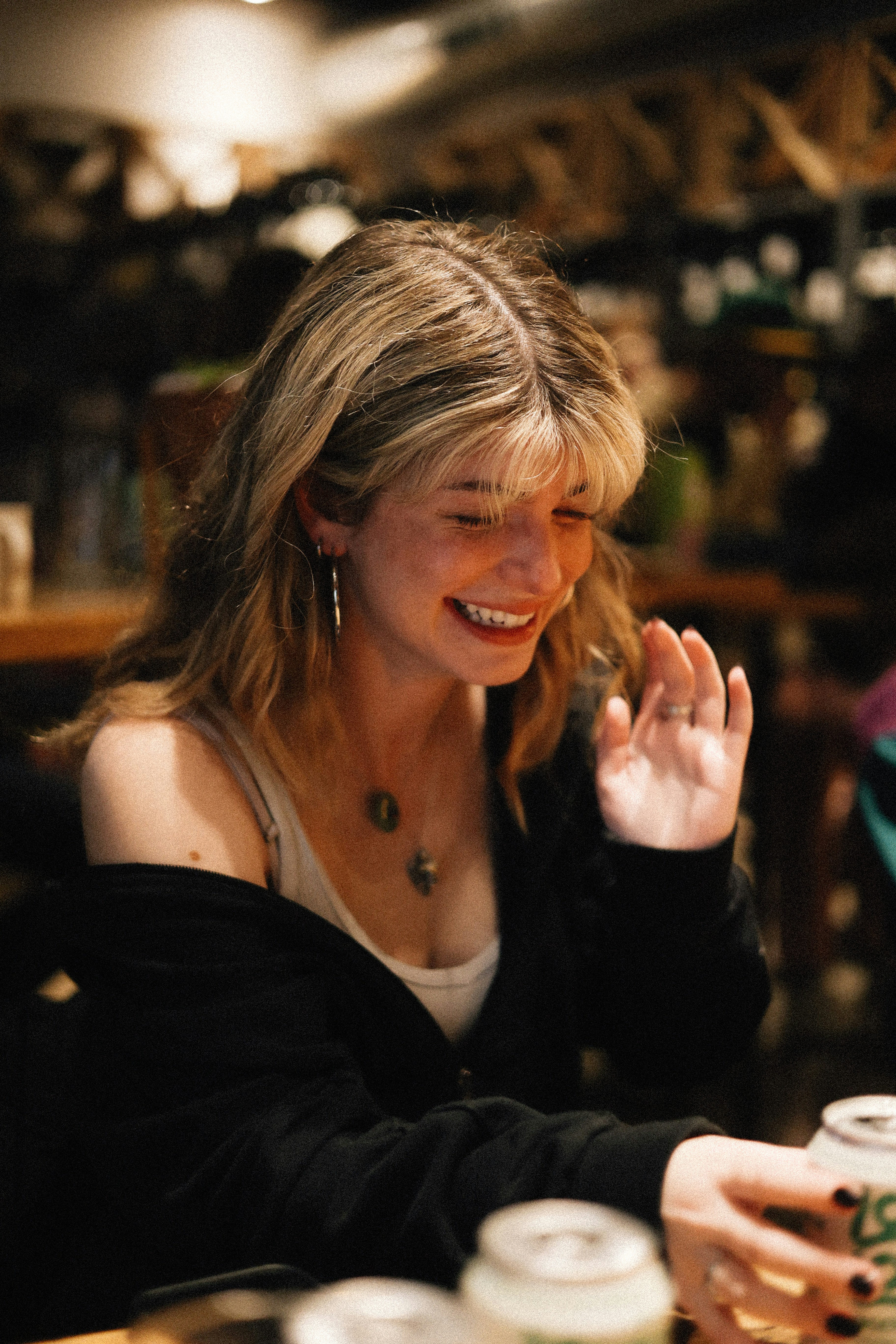 A happy woman sitting at a table | Source: Unsplash