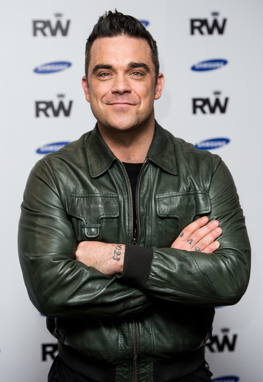 Robbie Williams attends a photocall to announce a forthcoming stadium tour for Summer 2013. | Source: Getty Images
