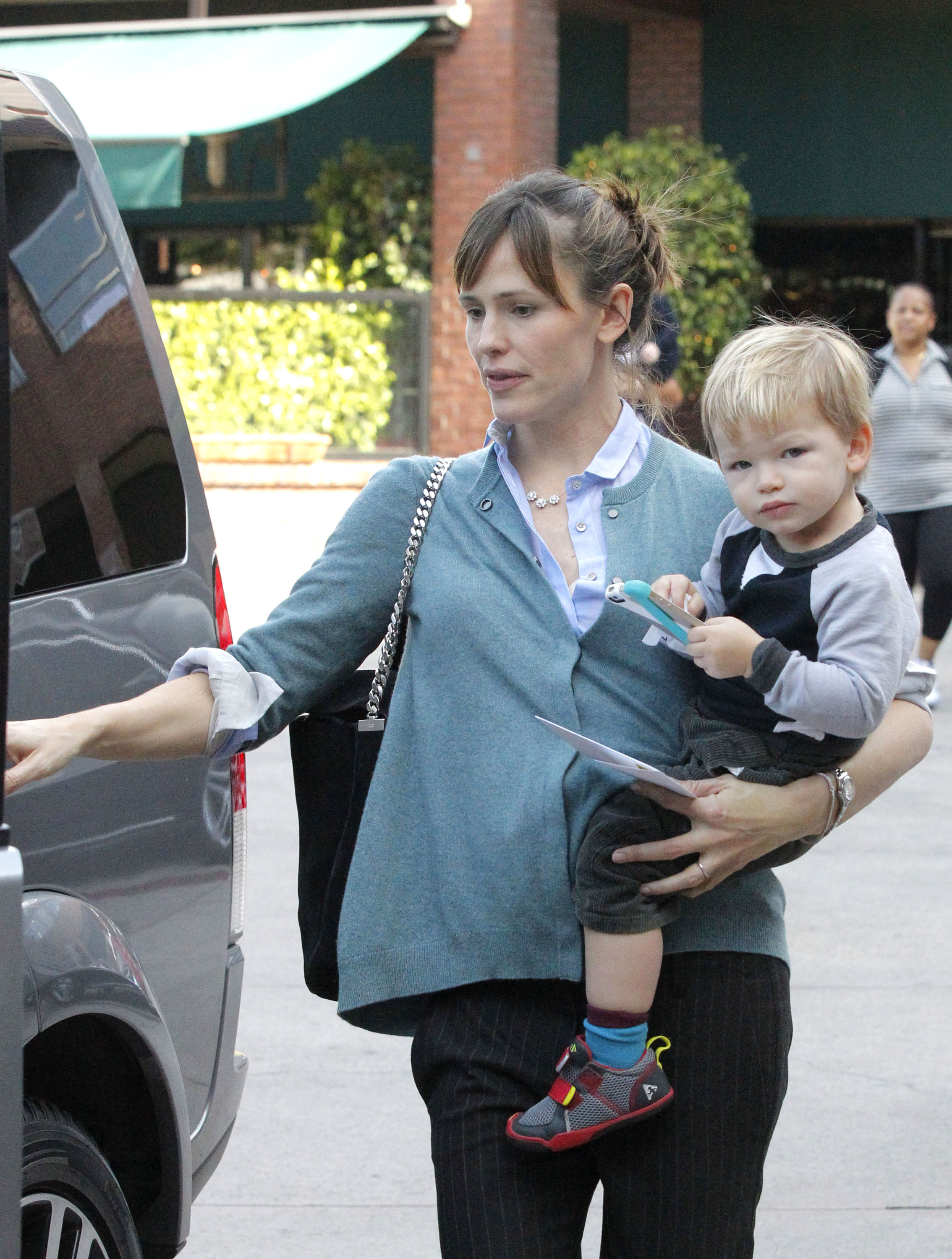 Samuel Garner Affleck looks at the photographer as his mother, Jennifer Garner, carries him on the way to a vehicle on December 17, 2013, in the Brentwood neighborhood of Los Angeles, California. | Source: Getty Images