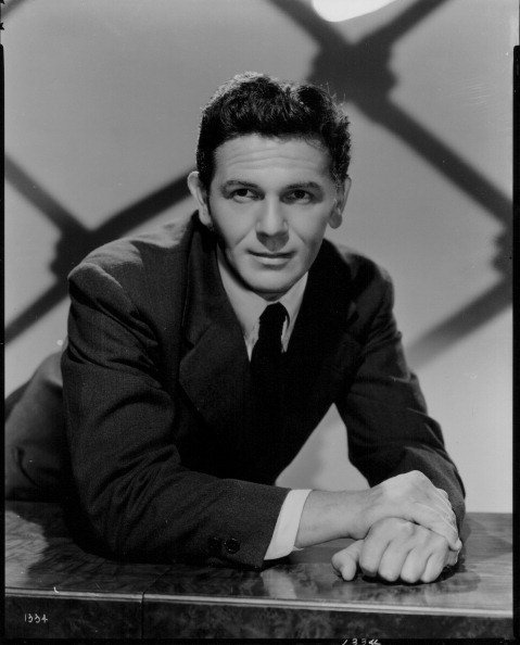 Portrait of actor John Garfield wearing a black suit and tie, circa 1945 | Photo: Getty Images