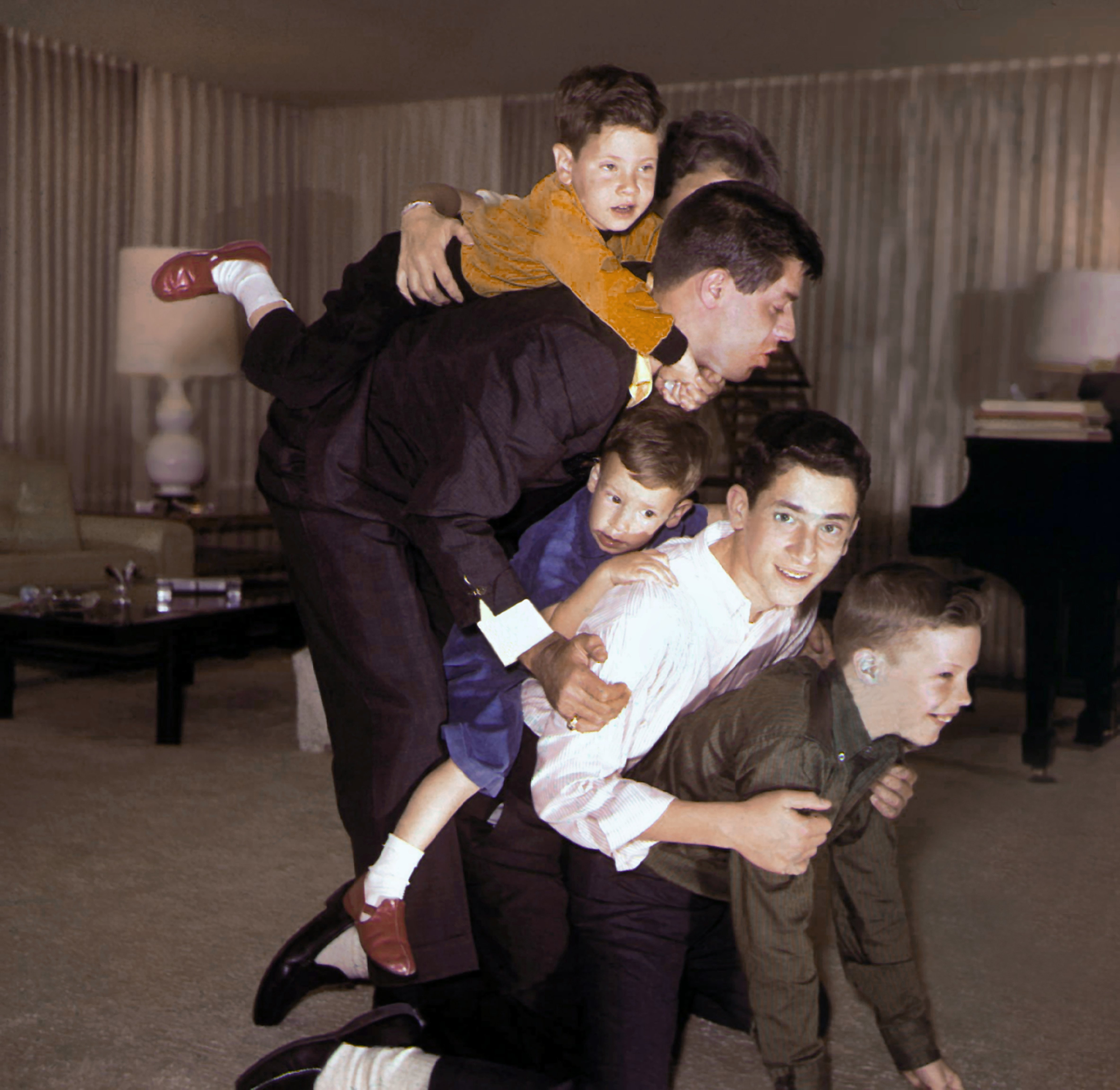 Jerry Lewis captured at home being playful with his four sons in 1956 in Los Angeles, California. / Source: Getty Images