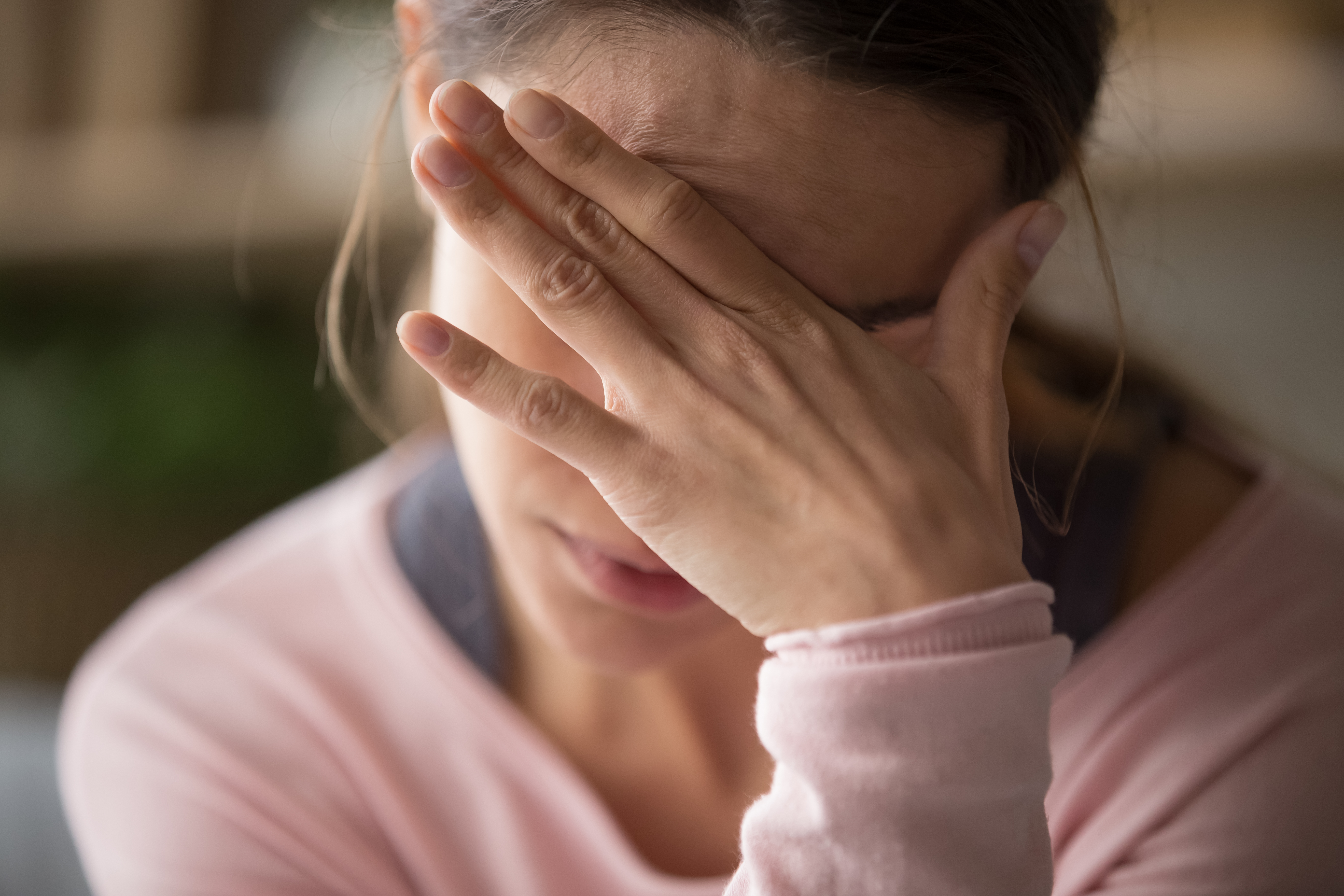 Upset frustrated girl troubled with problem feel stressed cover crying face with hand. | Source: Shutterstock