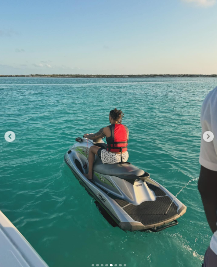 Brandon Clarke rides a Jet Ski across clear turquoise water while wearing a red life vest during a vacation outing. | Source: Instagram/brandon_clarke23