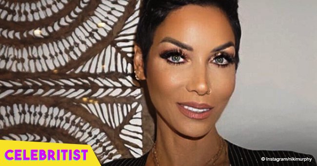 Nicole Murphy flaunts deep cleavage & taut tummy in tiny lace top, dancing with Ludacris in video