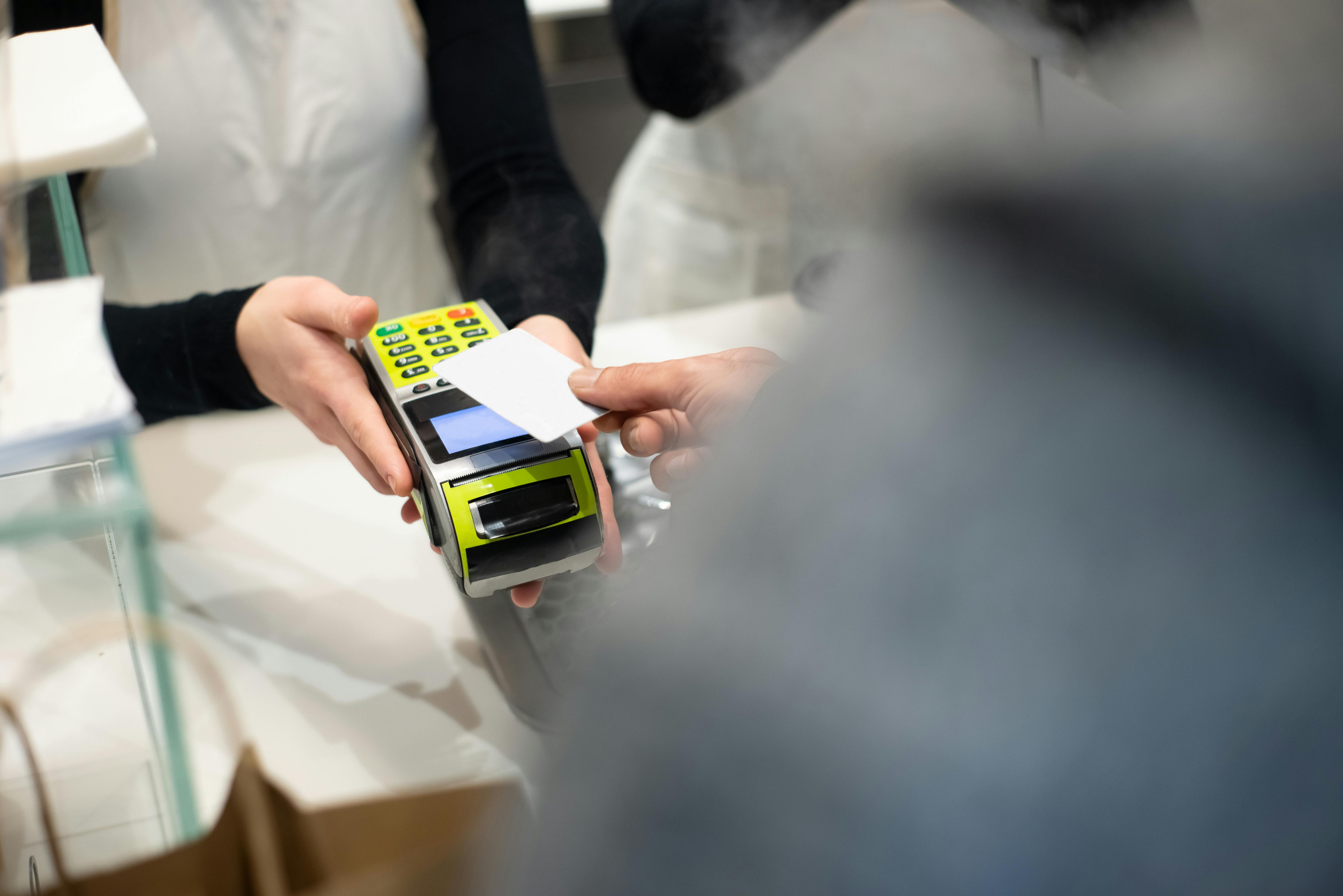 A person holding out a credit card | Source: Pexels