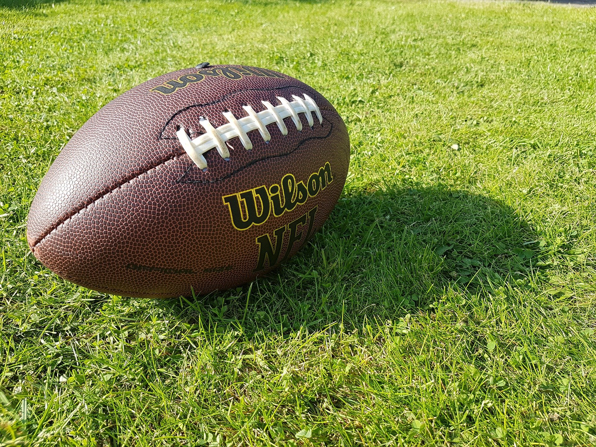 A football on a field. | Photo: Pixabay/Oliver Cardall