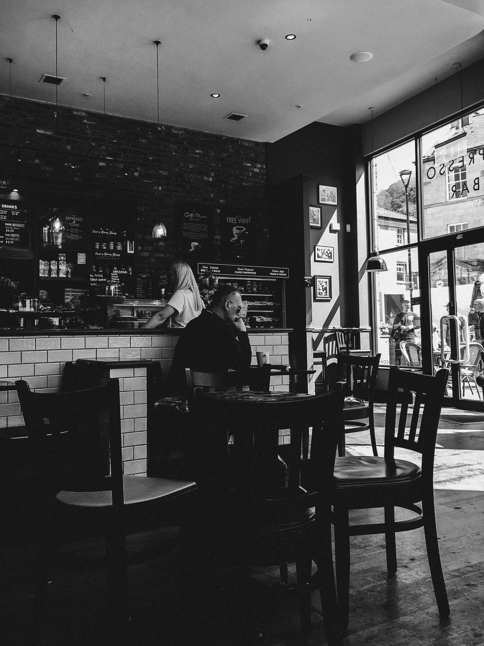 A man seating alone in a bar | Photo: Pexel