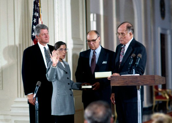 Marty holds the bible as Ruth is sworn in as a Supreme Court justice of the United States, Washington, DC, on August 10, 1993. | Photo: Getty Images