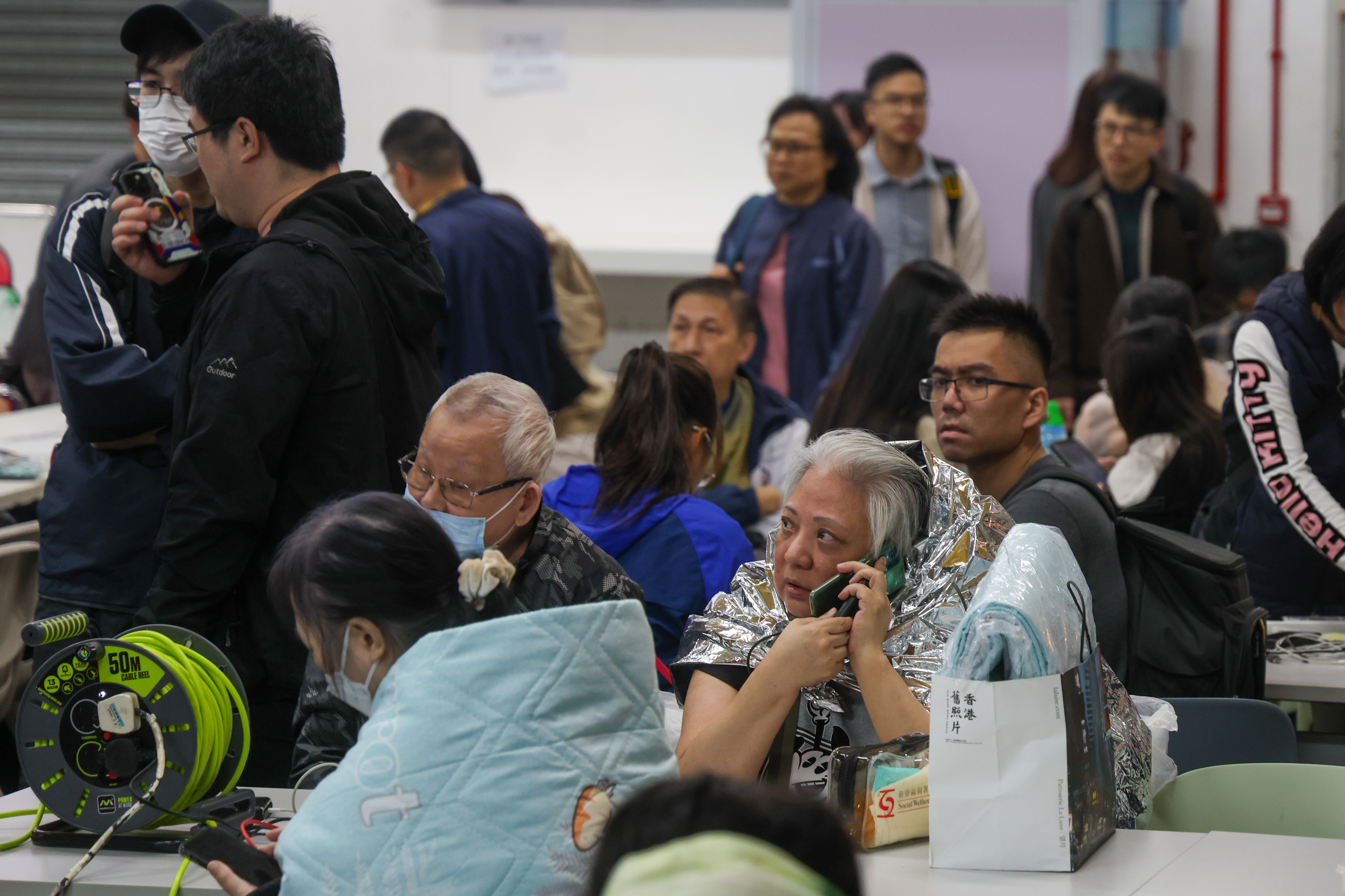 Residents take refuge at a temporary shelter after a fire broke out at the Wang Fuk Court in Hong Kong, China, on November 26, 2025. | Source: Getty Images